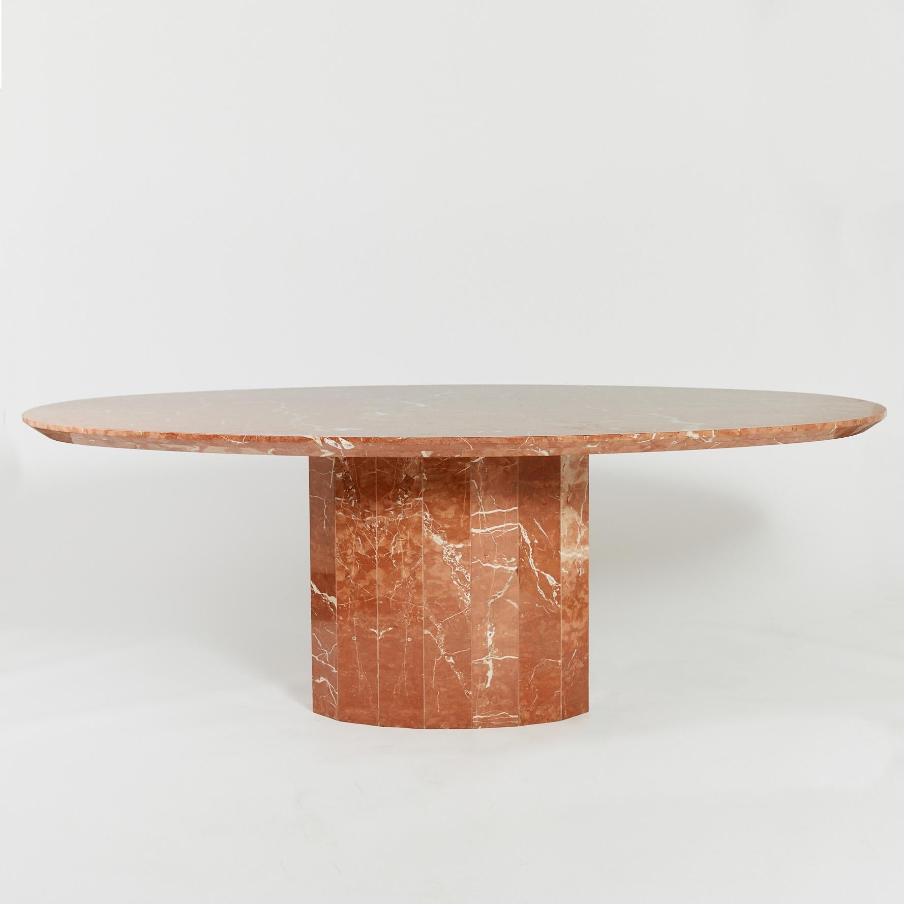Iconic marble 6-8 seater dining table with faceted pedestal base and vivid veining on large oval top.

Featuring an extremely thick table top, this rare statement piece is made from Rojo Coralito marble and has a polished finish.

Origin: