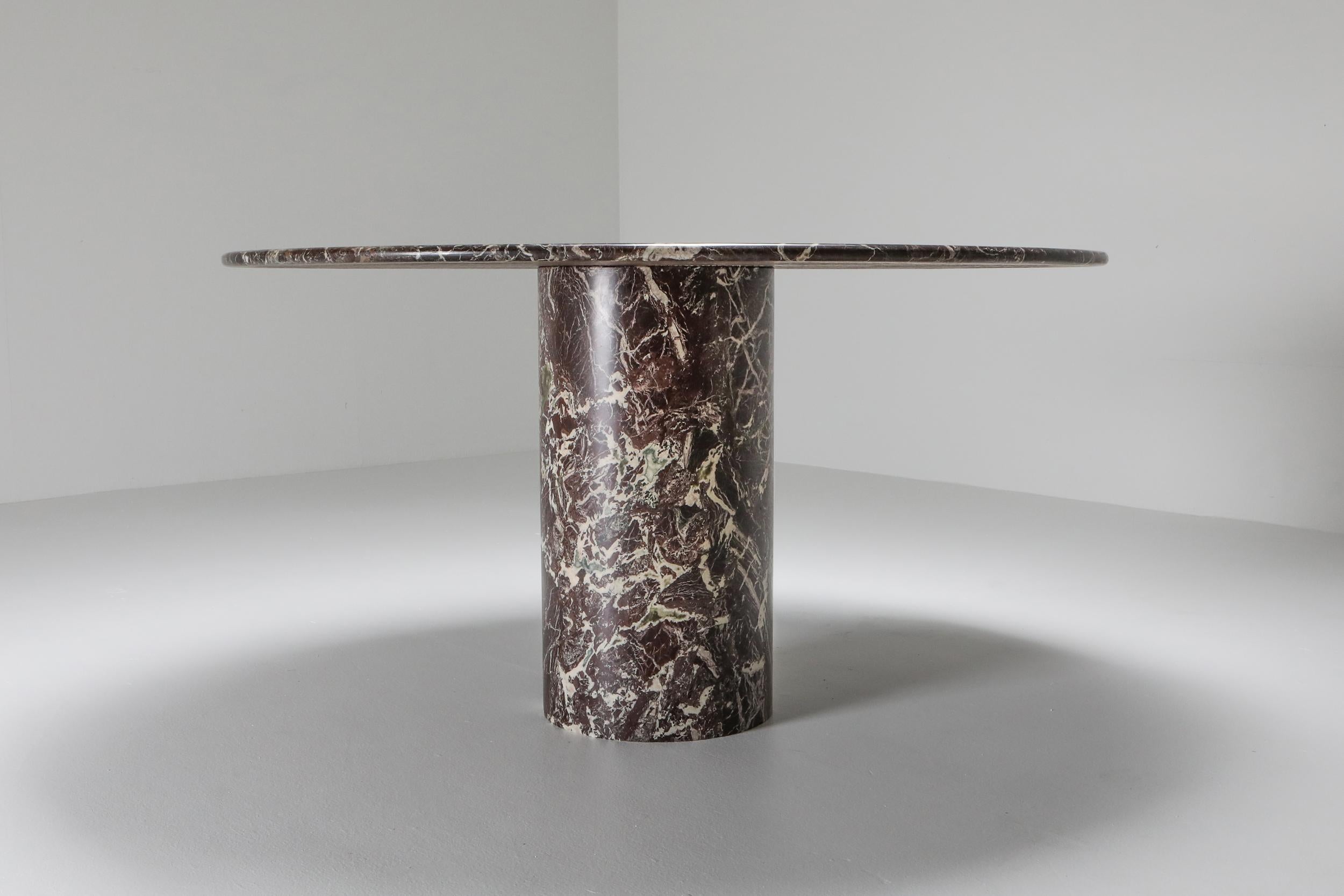 Mangiarotti attributed dining table, rosso levanto marble, Italy, 1970s

Round top on a cylindrical base.
Dark burgundy color
We presented these with the most gorgeous chairs ever.
The Africa chairs by Afra & Tobia Scarpa.
