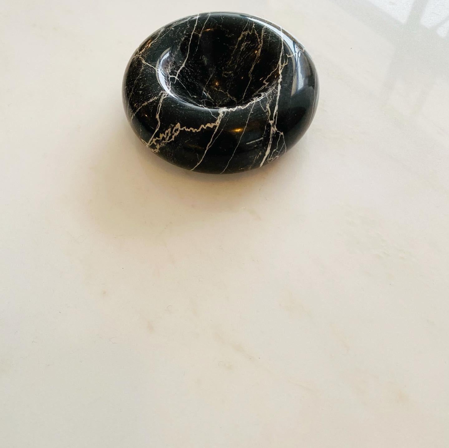 A collection of Conchetta model marble dishes or bowls or vide poche designed by Egidio Di Rosa and Pier Alessandro Giusti for Up & Up International. One black Marquina marble and three travertine marble of different travertines.
All are 4