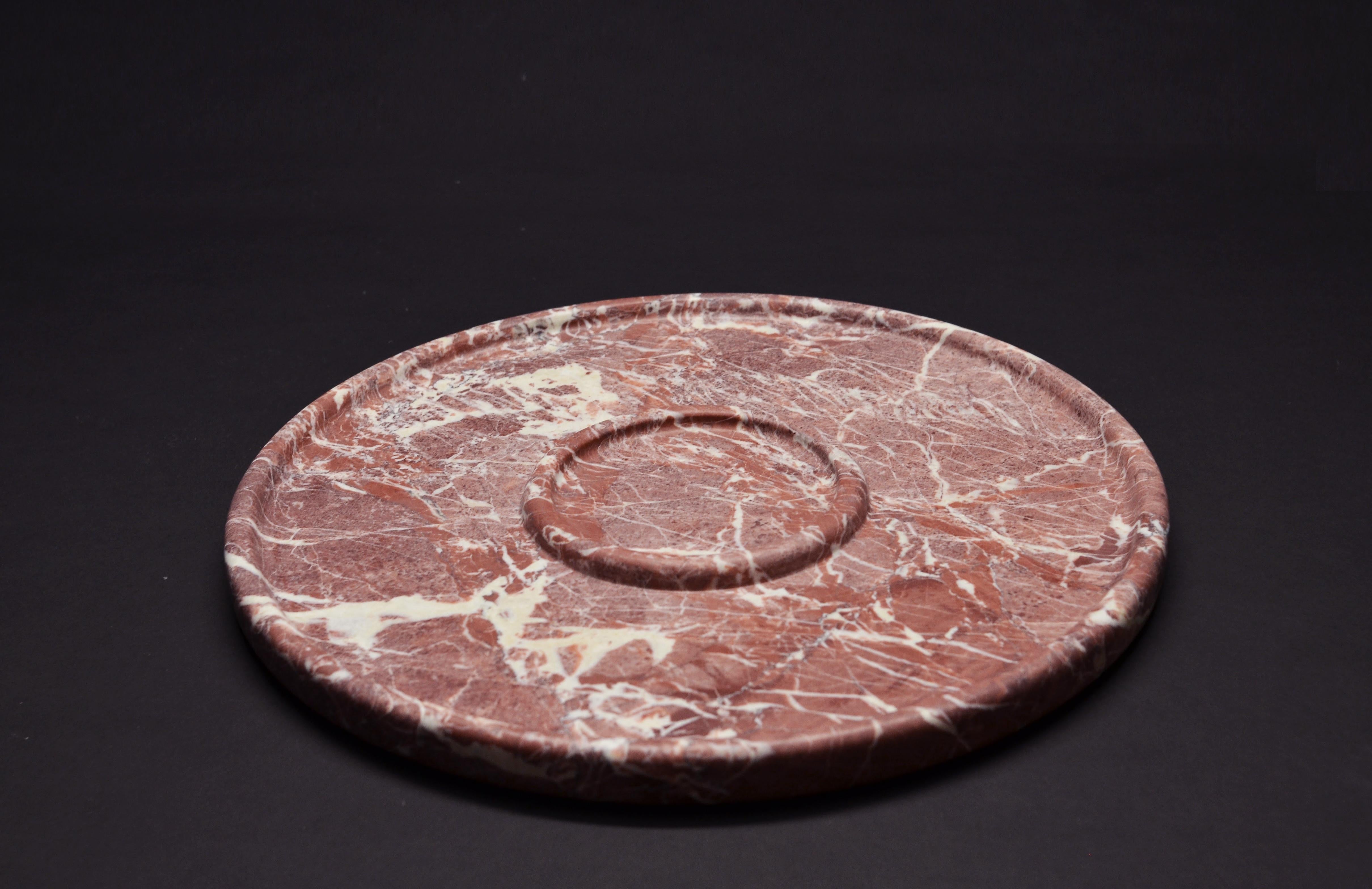 A fruit plate made from hand carved Ritsona Royal-red marble with white veins. Two concentric rings, a large one 35ø, with a smaller one 11.5ø.

Dimensions: 38 ø x 2.3 H cm

Care: Because marble is porous, stains can penetrate into the crystals.