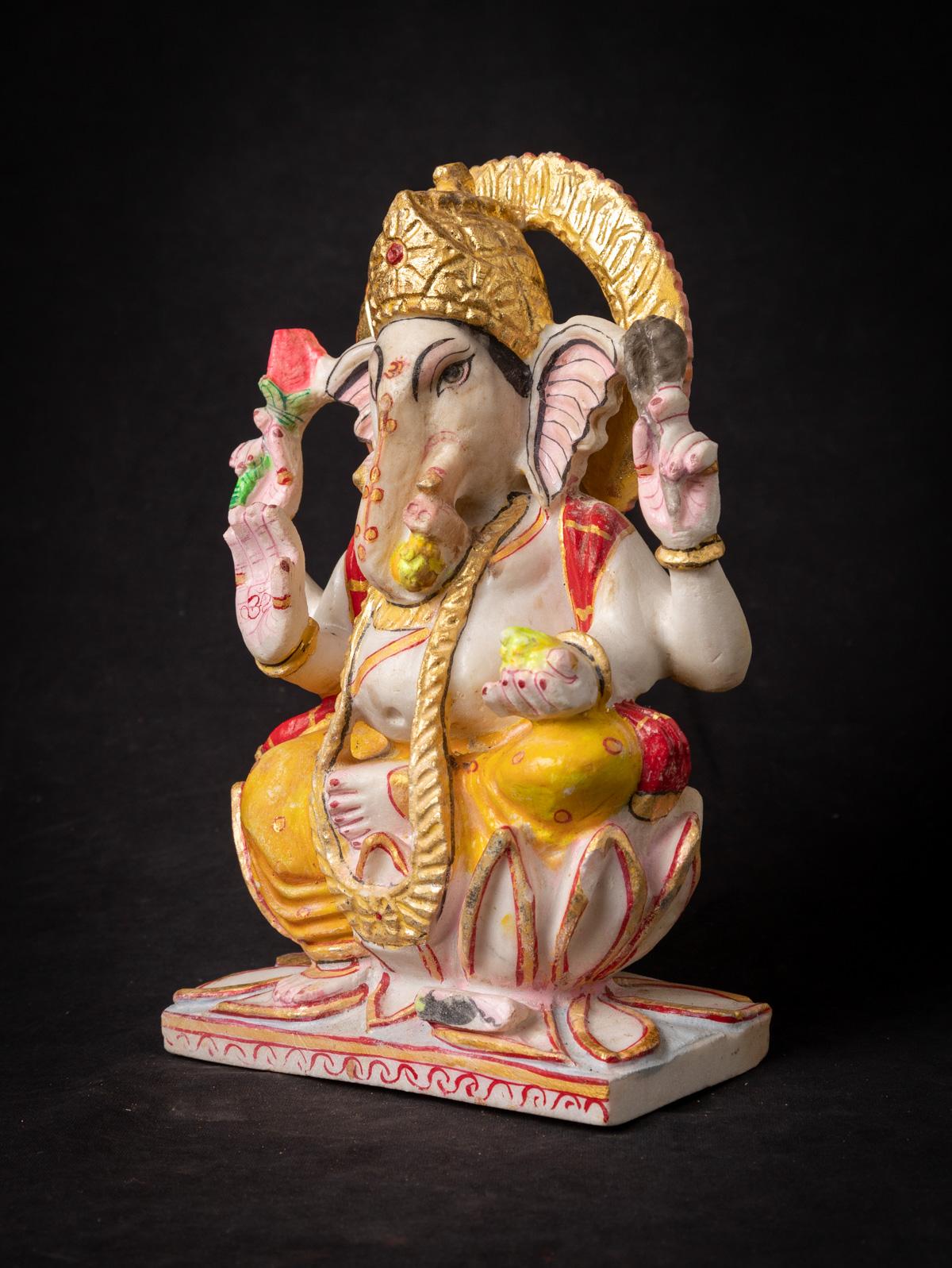 This Indian marble Ganesha statue is a magnificent work of art that embodies the essence of the elephant-headed deity, Lord Ganesha. Crafted from marble, it stands 28.5 cm tall, with dimensions of 17.8 cm in width and 9 cm in depth. Despite being