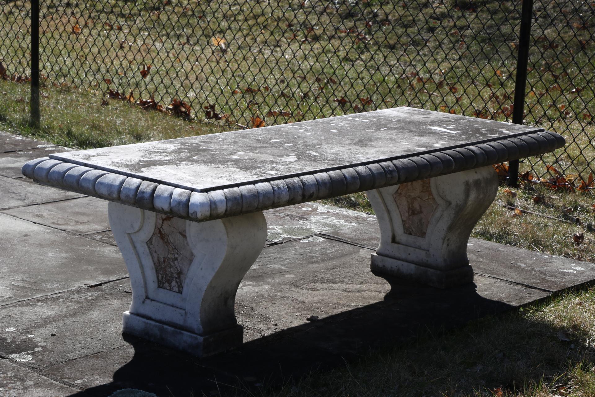 Pair of marble garden benches, spectacular pair of excellent condition marble garden benches with perfect proportions, gadrooned seat edge and scrolled variegated marble panel inlaid bases. Weathering over time has given the Bench tops a wonderful
