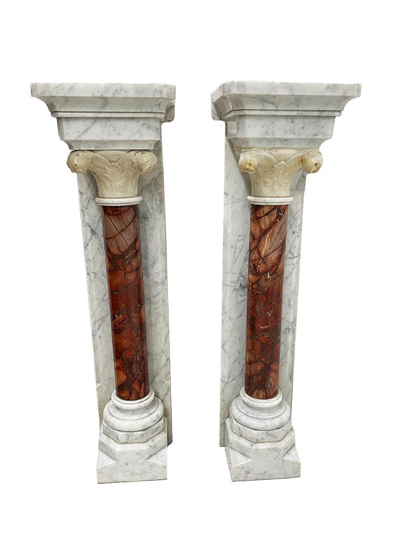 Marble half wall mounted columns, 19th Century

Half wall mounted columns of marble with alabaster. 
White gray wall columns with red, brown pillars and alabaster capitals on top. 
The right column has been restored and has an extra marble plate