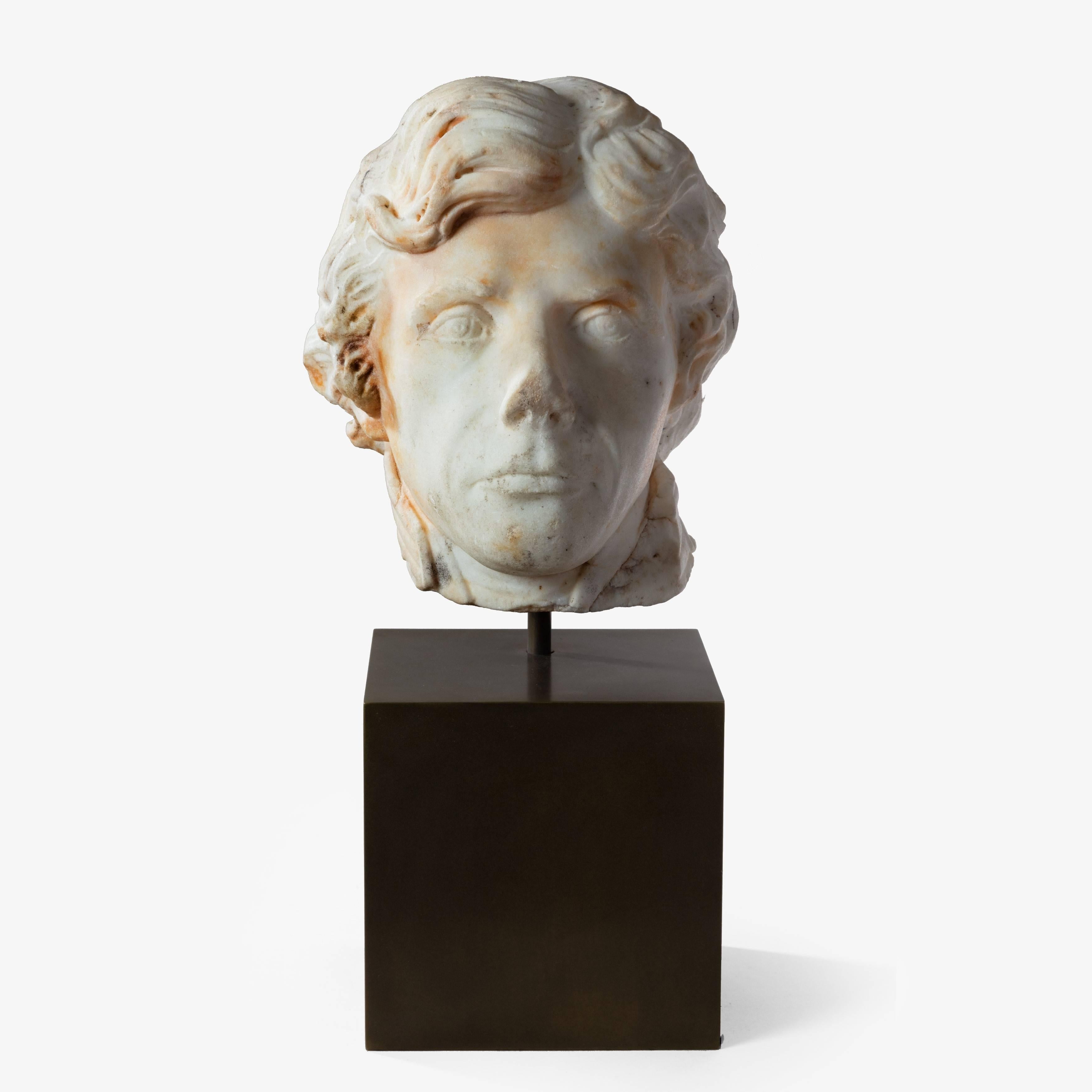 A Marble Head of Admiral Lord Nelson from a bust by or after Thaller and Ranson, circa 1801-1805 The antique condition life-size head shown looking forward and mounted on a later bronzed wooden plinth.

Height of head: 11” (28cm) Overall height: 18”