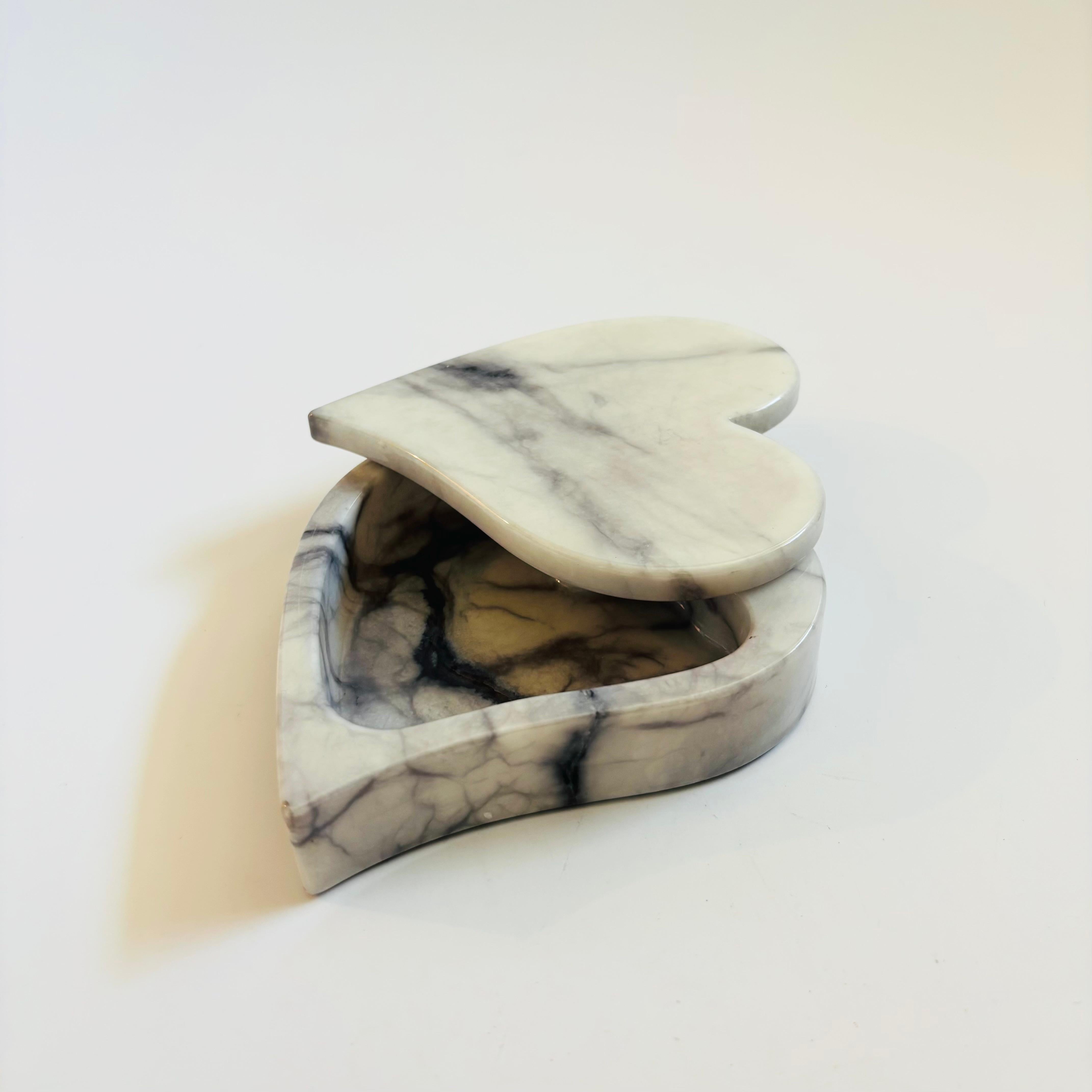 A vintage marble heart shaped box. Swivel top with beautiful natural veining and gray coloring to the stone. Perfect for using as a jewelry box. Made in Italy by Ducceschi, original sticker on the base.



