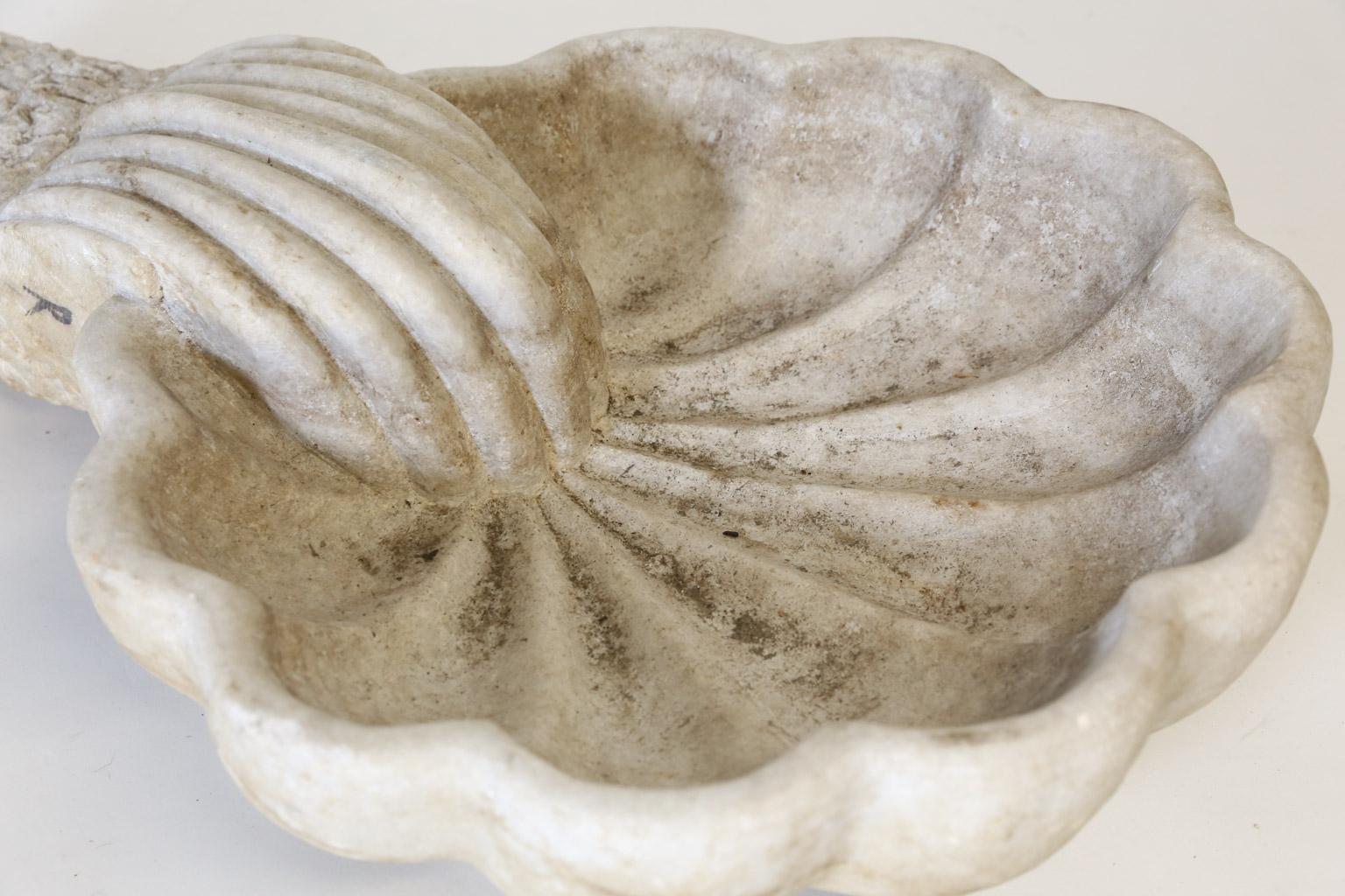 This is a beautiful Catholic Holy Water font in the shape of a scallop shell which is symbolic of the start of a pilgrimage journey through life. John the baptist poured water from the Jordan River with a scallop shell to baptize Jesus Christ. Made