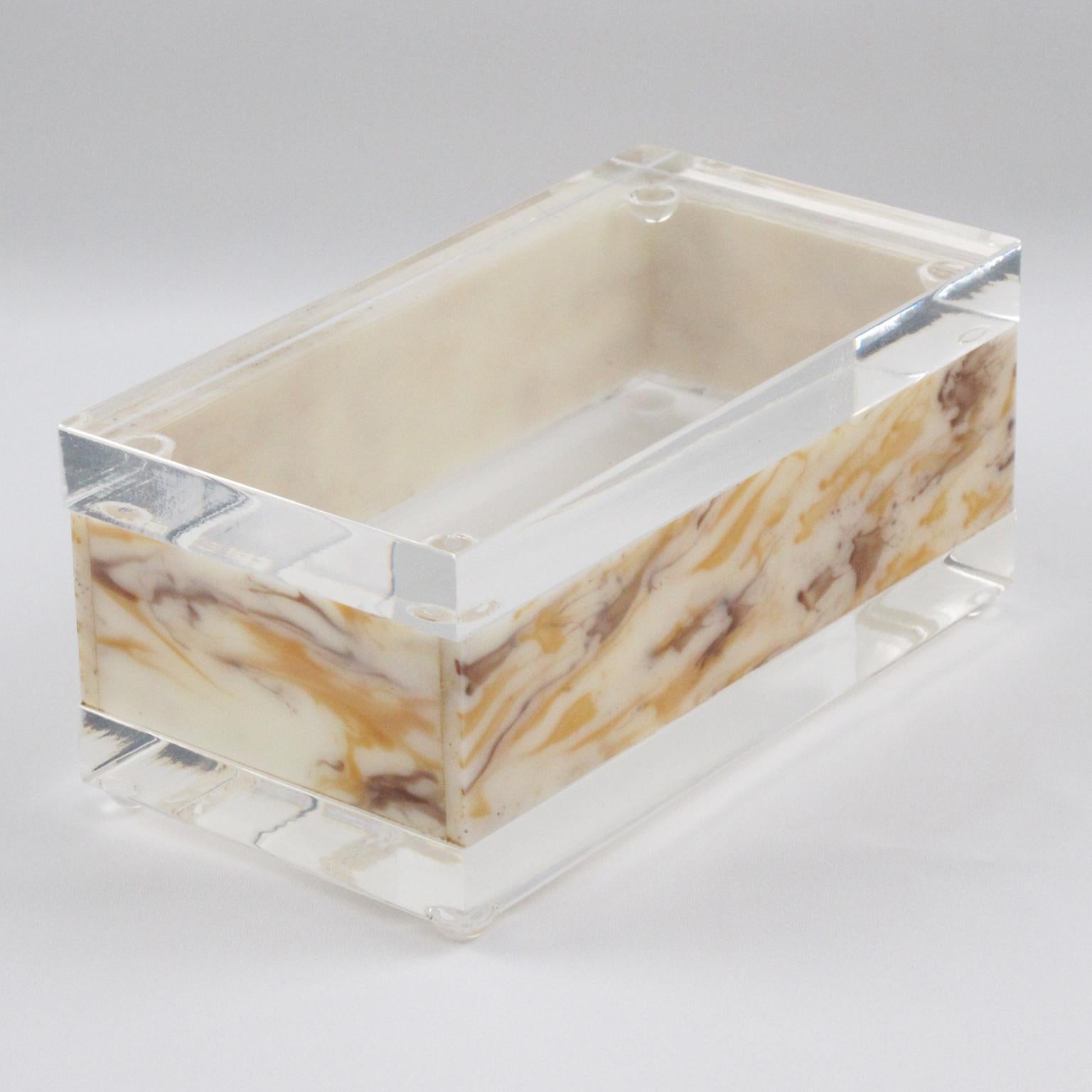 This lovely modernist Lucite box was crafted in the 1970s. The rectangular shape boasts a crystal clear Lucite or Acrylic and faux marble textured pattern. The stunning milky honey and amber swirl color looks like genuine marble. There is no visible