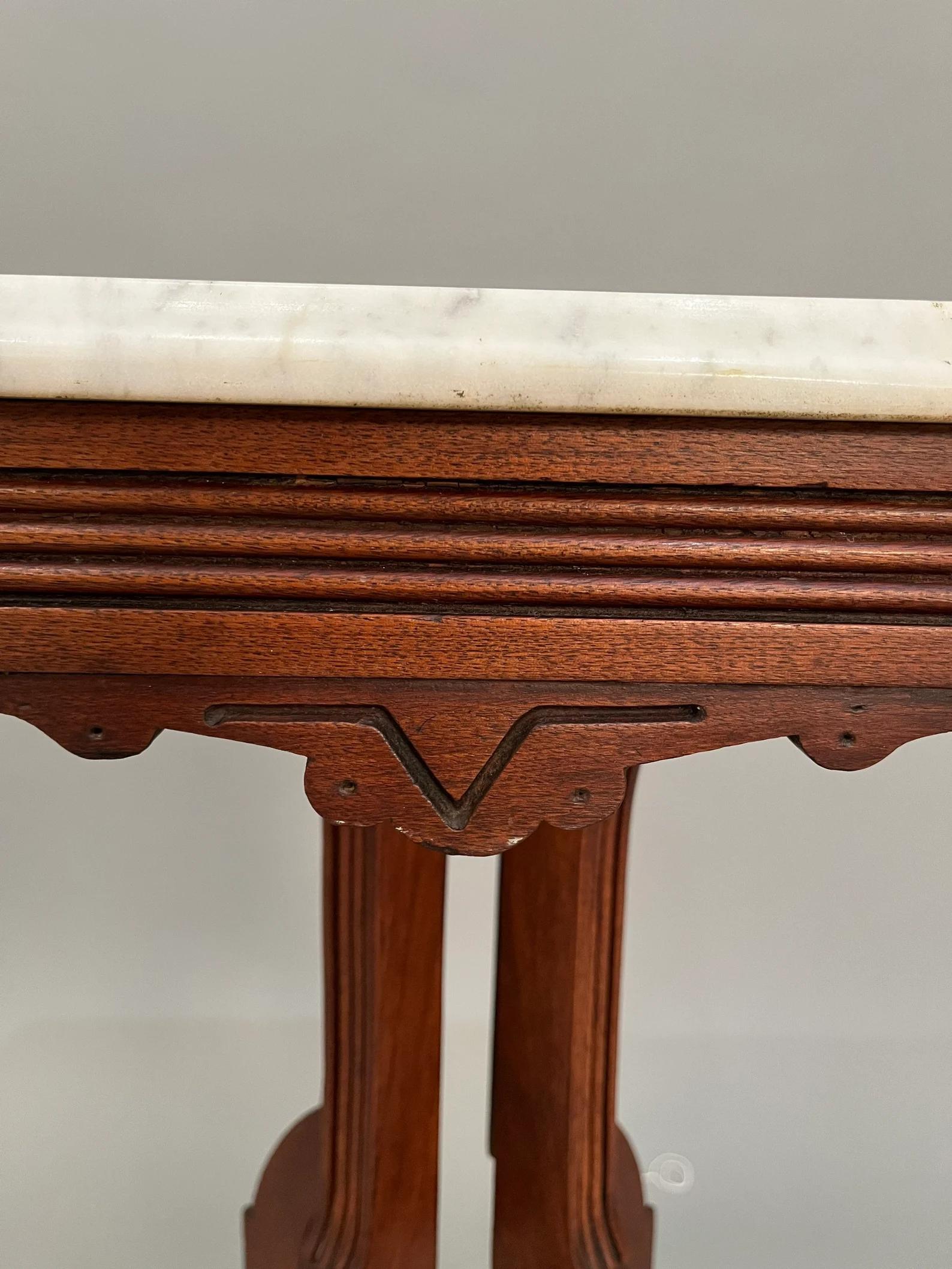 Marble / mahogany table with castor wheels 1950s
W24” x D18” x H30” inches.