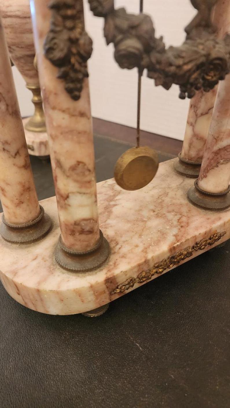 This listing features a French Empire style mantel clock along with two matching urns. Also known as Neoclassical style, French empire style was a widespread and influential movement in painting and other visual arts that began in the 1760s, reached