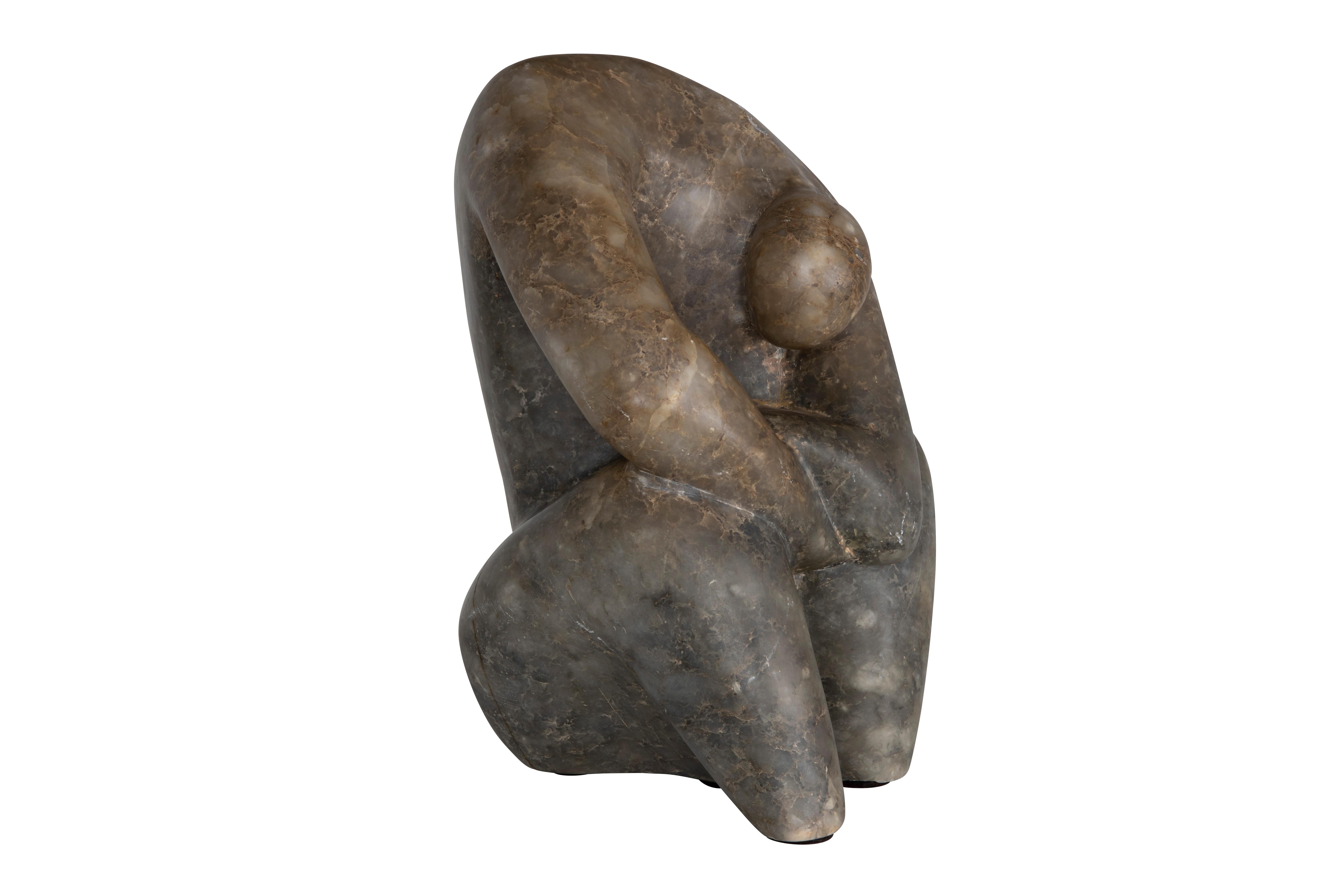 Rare organic modern abstract sculpture depicting a crouched human figure. Hand-carved from a single piece of dark marble stone with gorgeous and intricate coloring. This monumental piece is in fair condition with minor scratching near the base.
