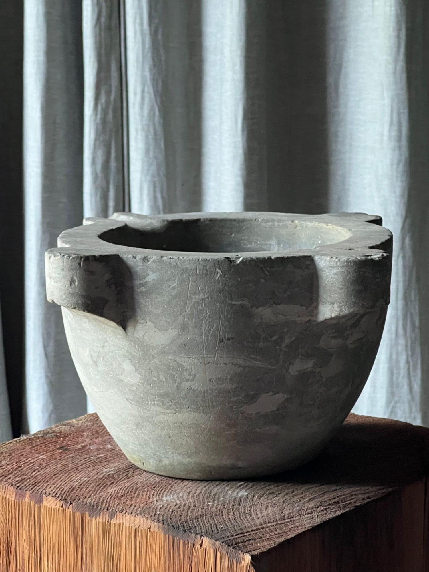 An antique light grey marble mortar, with four thick lugs and a pouring channel. Spanish 19thC H 22cm
W 41cm