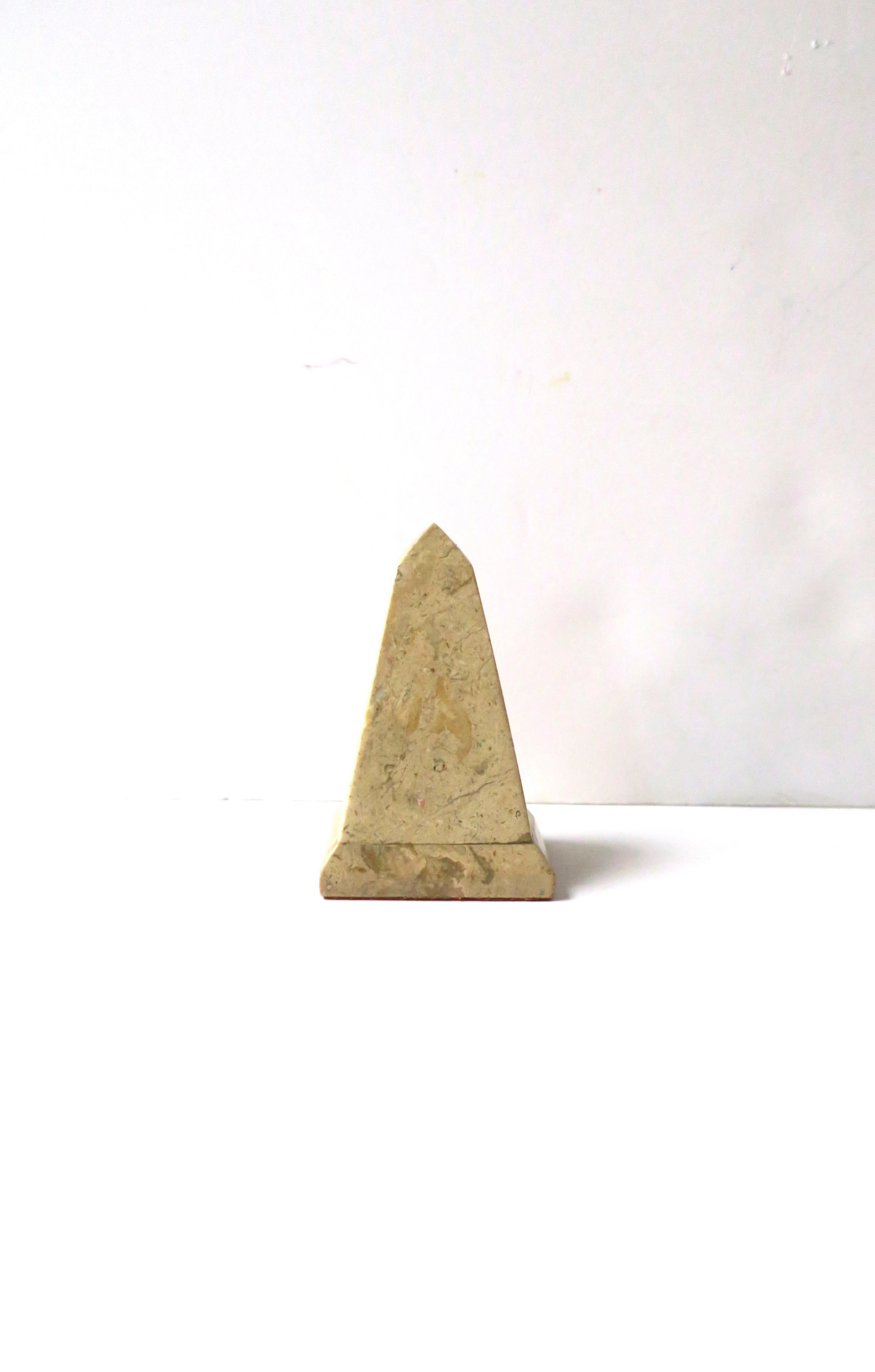 A small, neutral, marble obelisk, in the Modern style, circa mid to late-20th century, 1960s, 1970s. Marble is a neutral marble stone similar to the hue of travertine marble. Piece makes a great decorative object for a bookshelf, desk, home office
