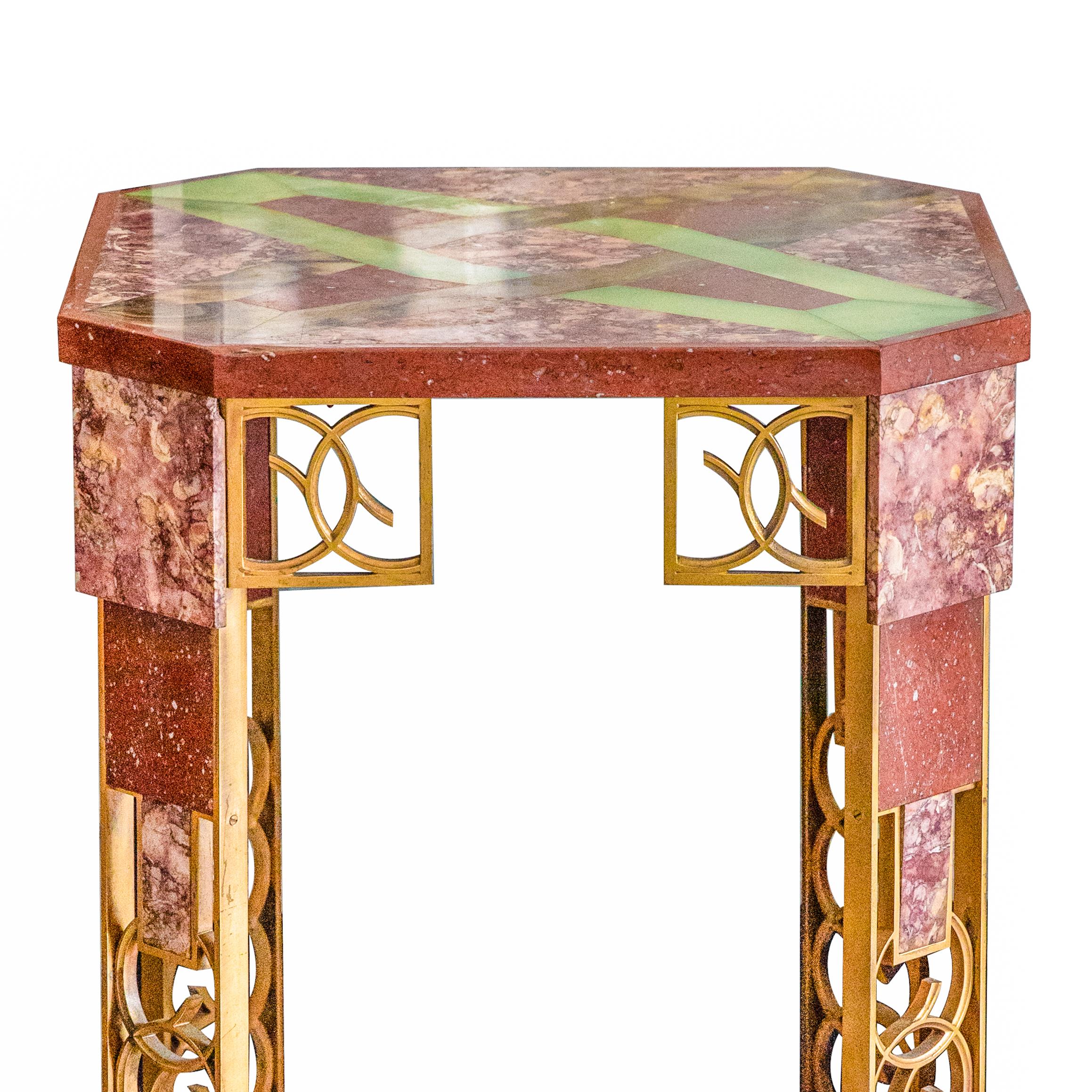 Offered is a marble, onyx, and gilt-bronze side table from the Collection of Walter P. Chrysler, Jr., France, circa 1925, the square marble top with cut corners inset in onyx with a pattern of interlocking devices, raised on angled legs composed of