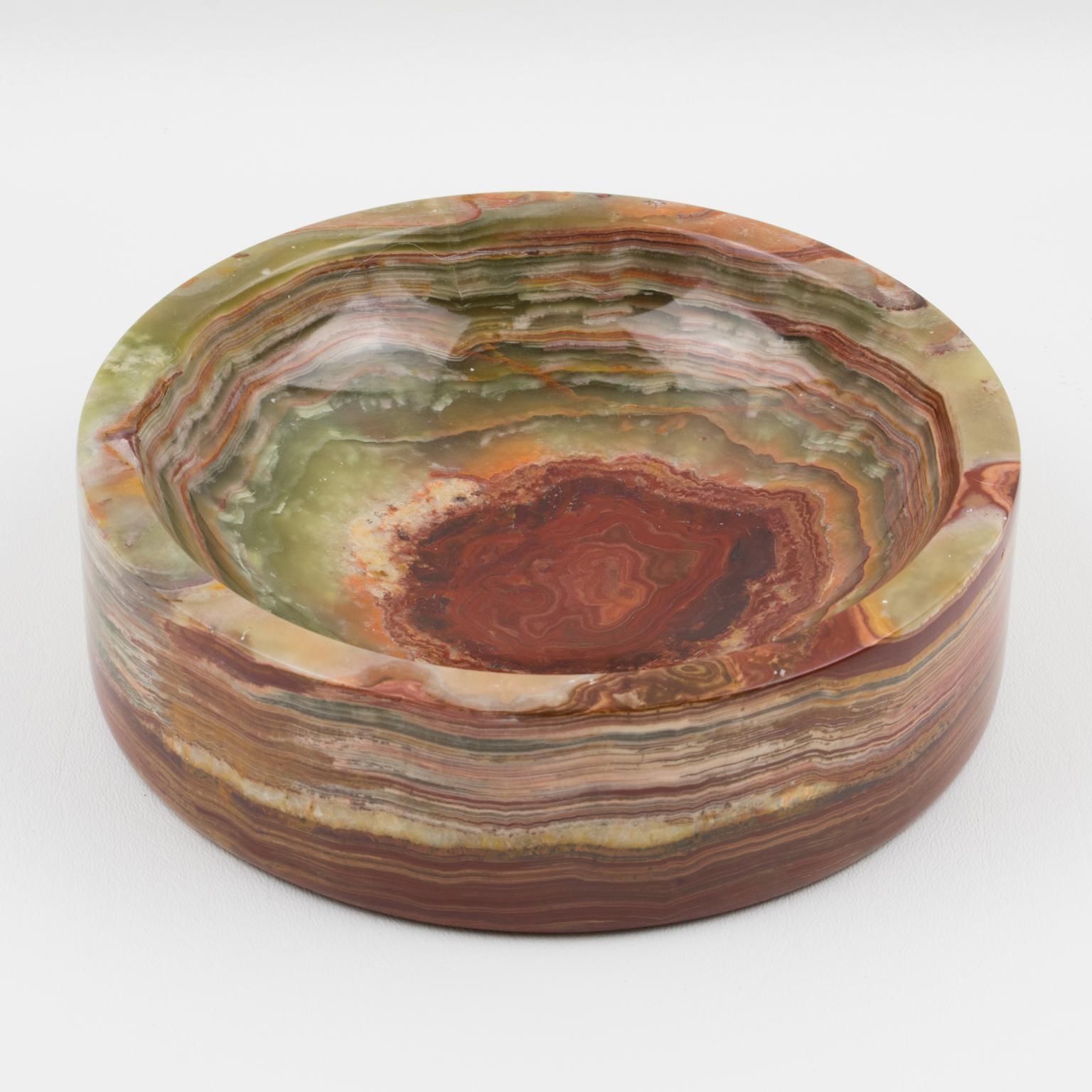 Elegant large 1970s Italian modernist marble onyx stone cigar ashtray, desk tidy, vide poche, or catchall. Rounded thick shape with rust and green color swirlings. No visible maker's mark.
Measurements: 7.07 in. diameter (18 cm) x 2 in. high (5 cm).