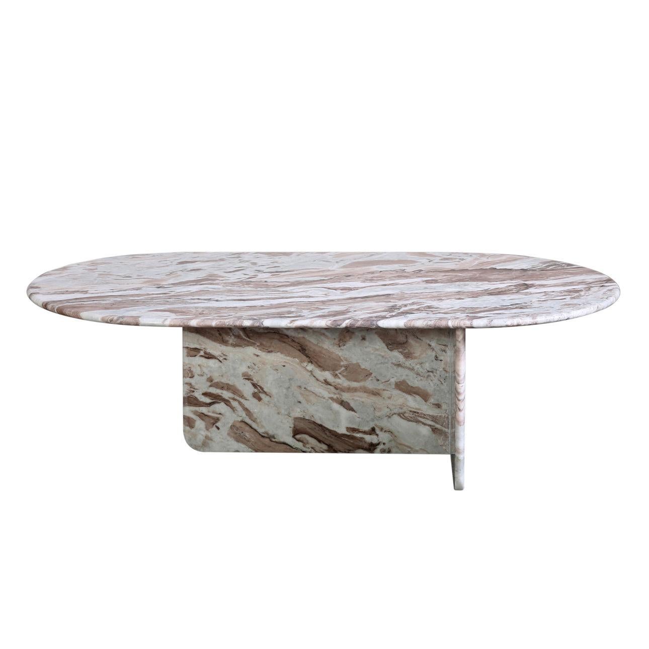 This solid Marble Oval Coffee Table is a sophisticated and timeless addition to any living space. Its modernity is emphasized by its uniquely asymmetric T-shaped base but the table remains organic through natural marble patterning. The table is