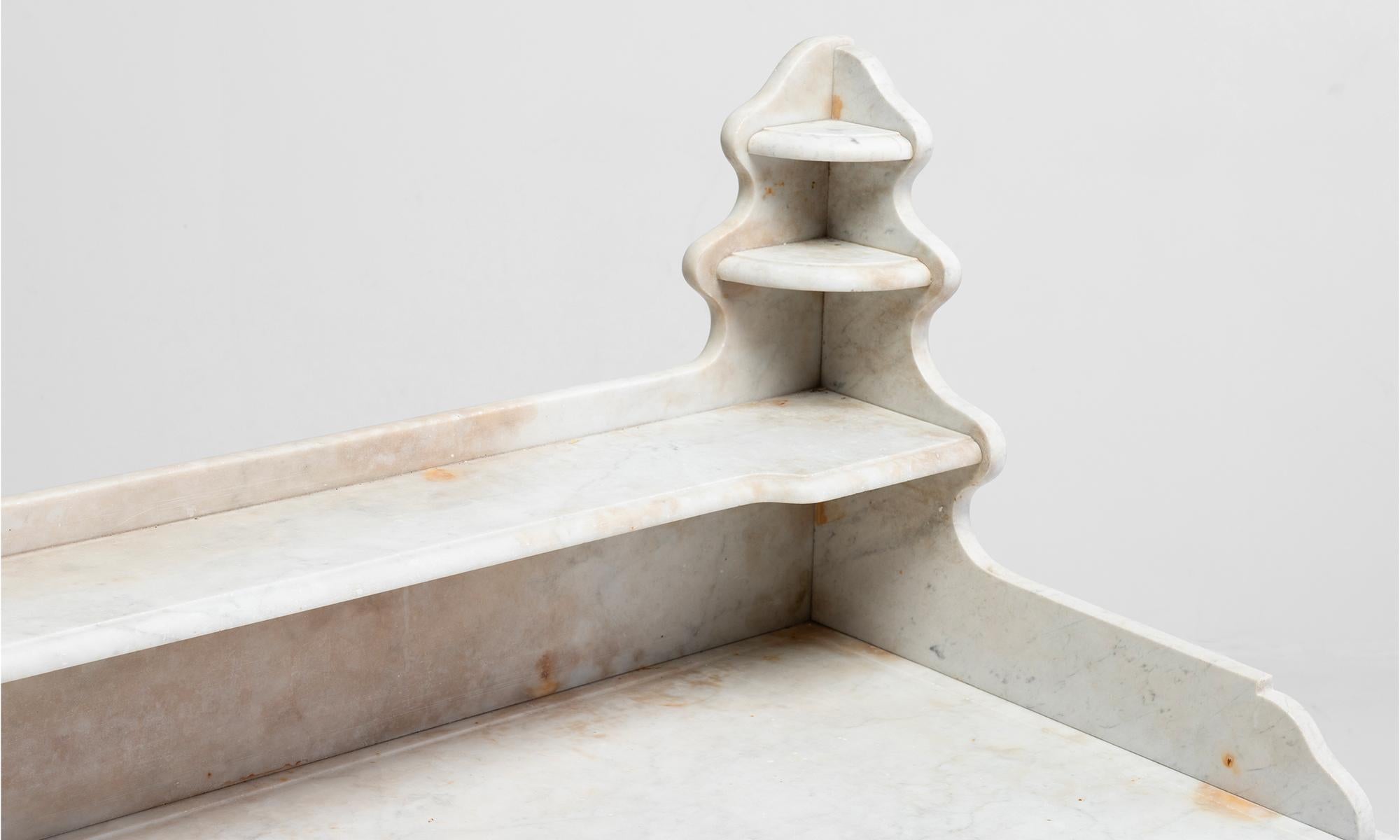 Marble pastry table, France, circa 1880.

Bleached oak with ornate iron hardware. White marble surface and shelving.