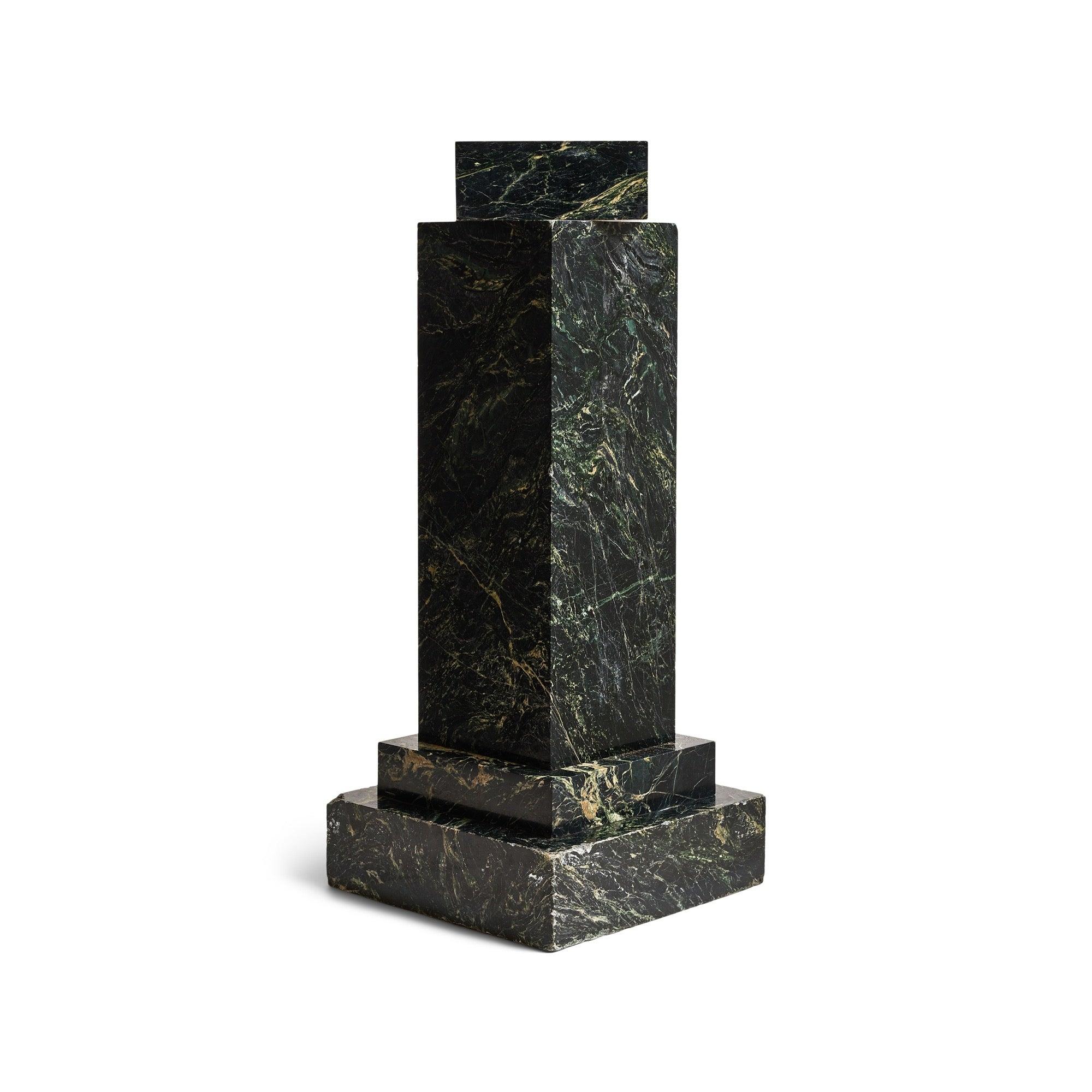 A black marble pedestal with greenish tint. The top portion rotates on a disk.
