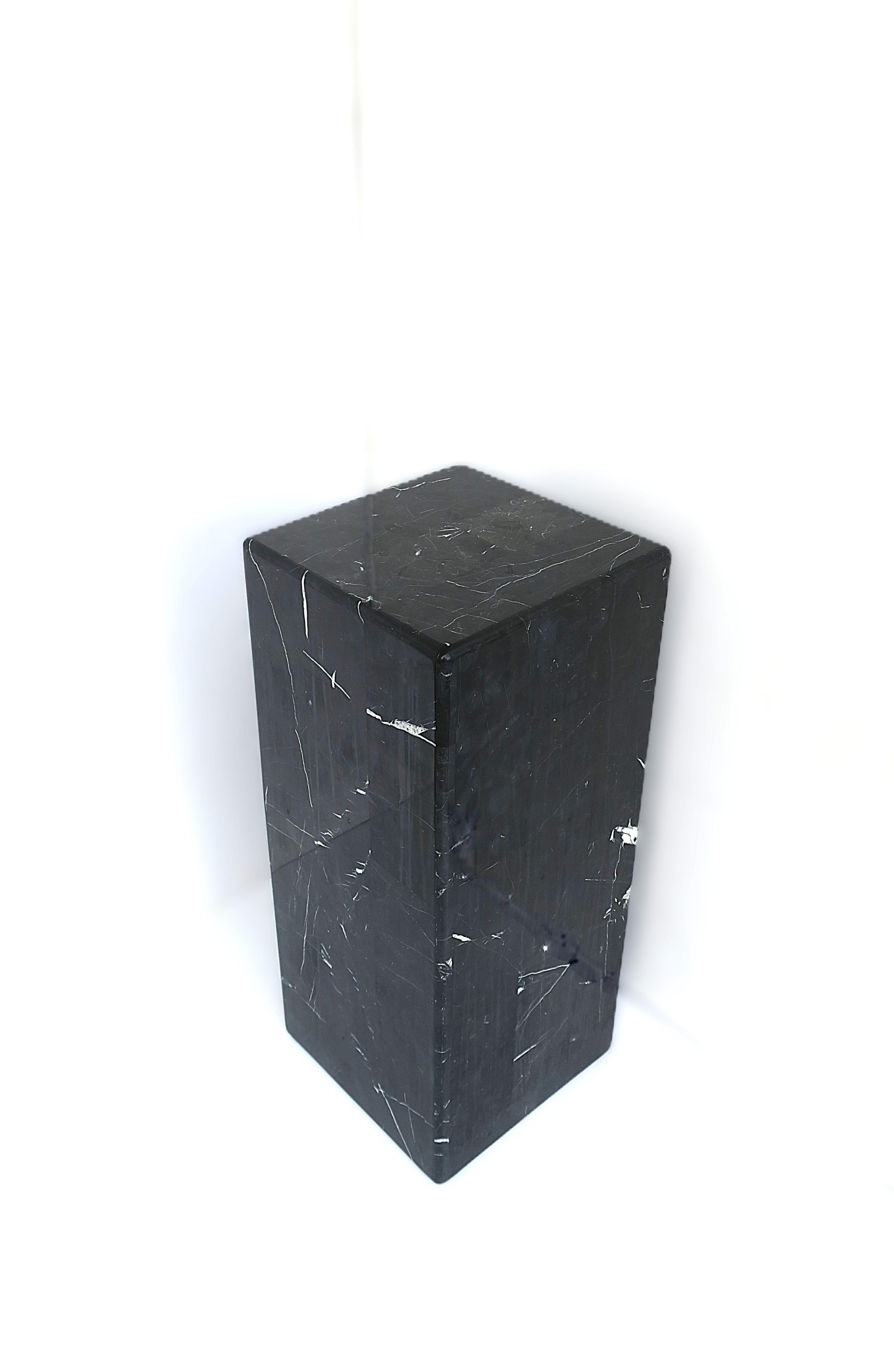 A black and white 'Nero Marquina' marble pedestal column or end/side/drinks table, Postmodern design period, circa late-20th century. Piece can be used to support art/sculpture, as a plant stand, or as an end/side/drinks table. Piece has a