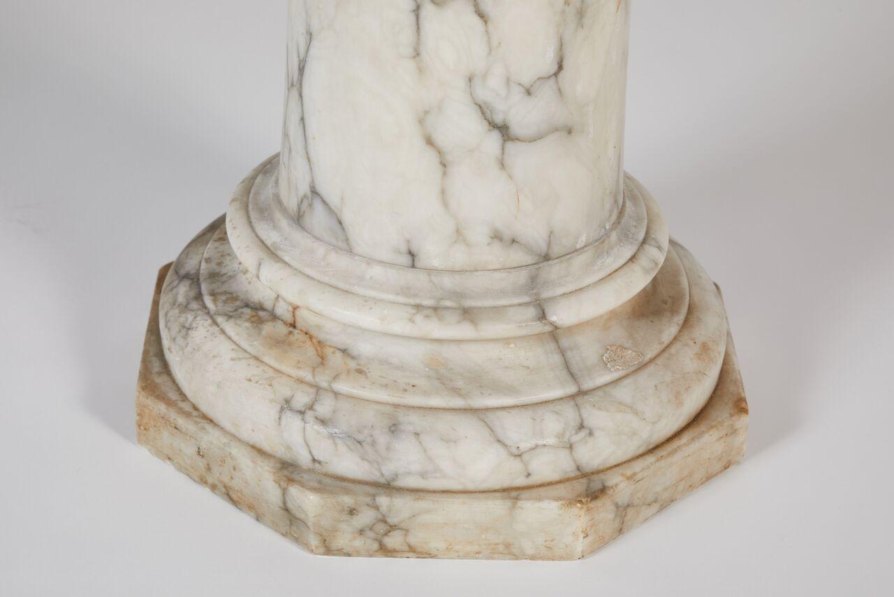 Marble pedestal sitting atop an octagonal plinth. With a generous top measuring 12