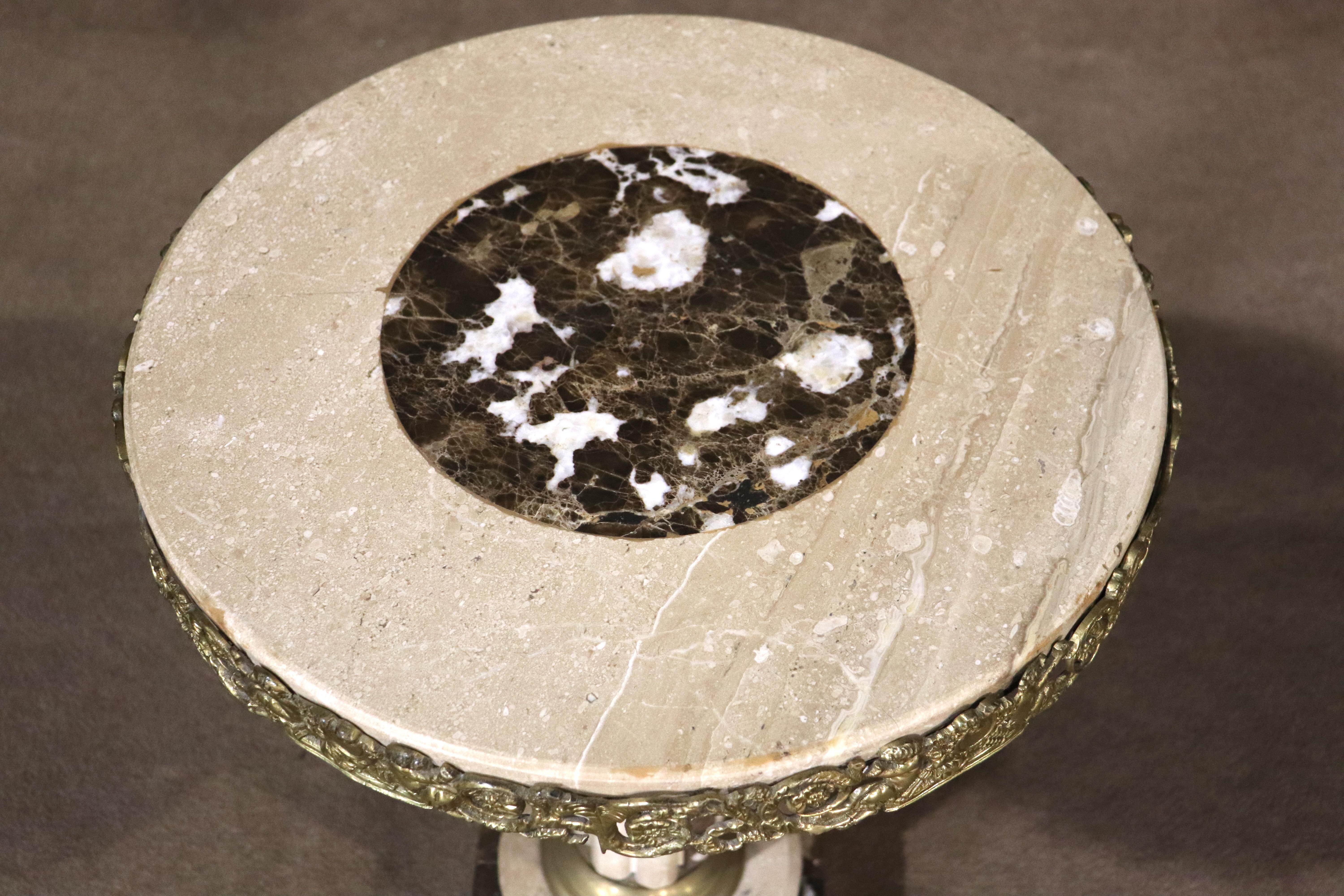 Round marble pedestal table with Greek column and brass trim.
Please confirm location NY or NJ