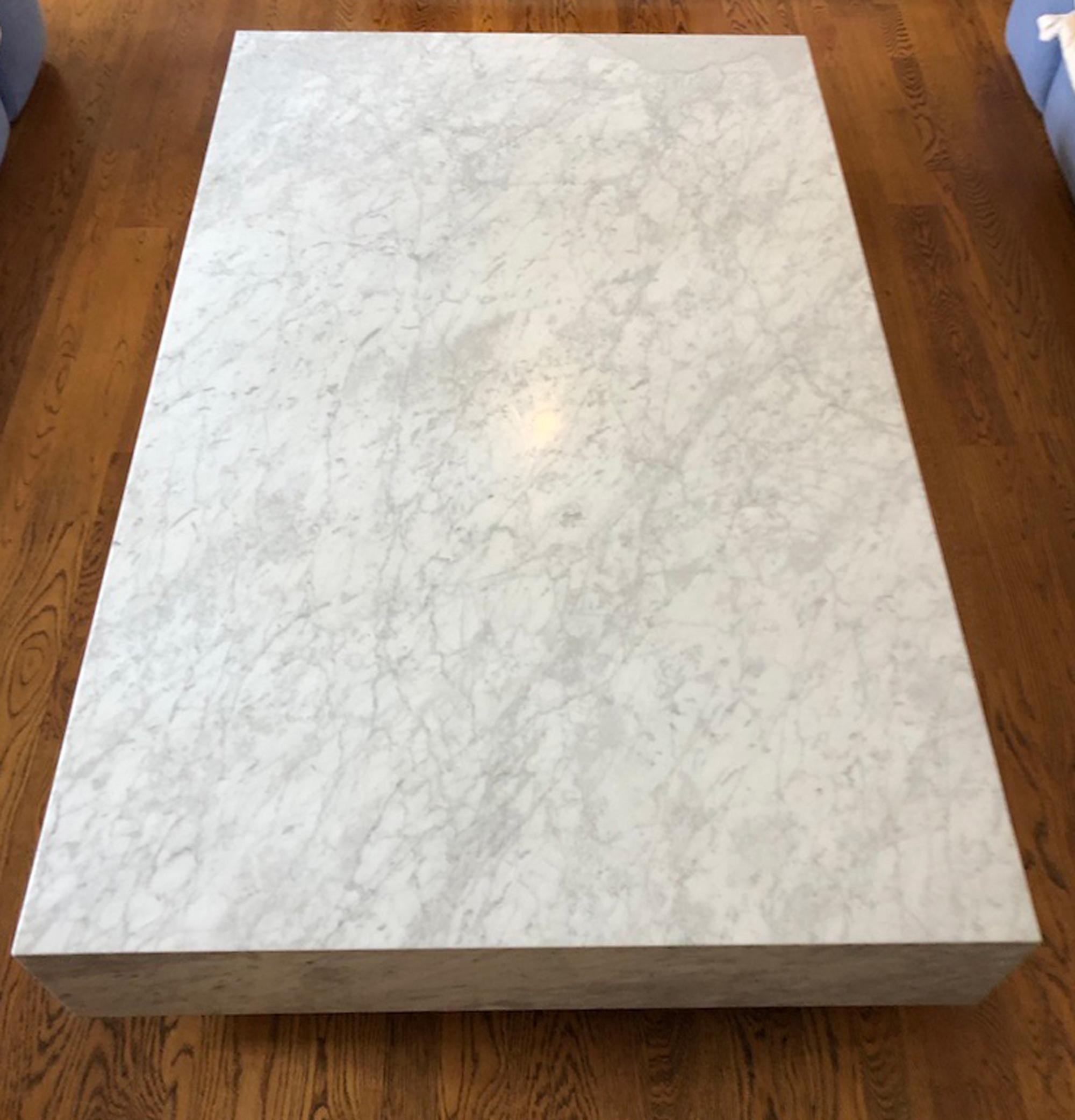 Handcrafted from slabs of marble on a sturdy wooden frame.
Thick, overhanging top is set on a low, inset base to create a floating effect.
Hidden casters allow ease of placement. Casters are not removable and do not lock.
Variations in the