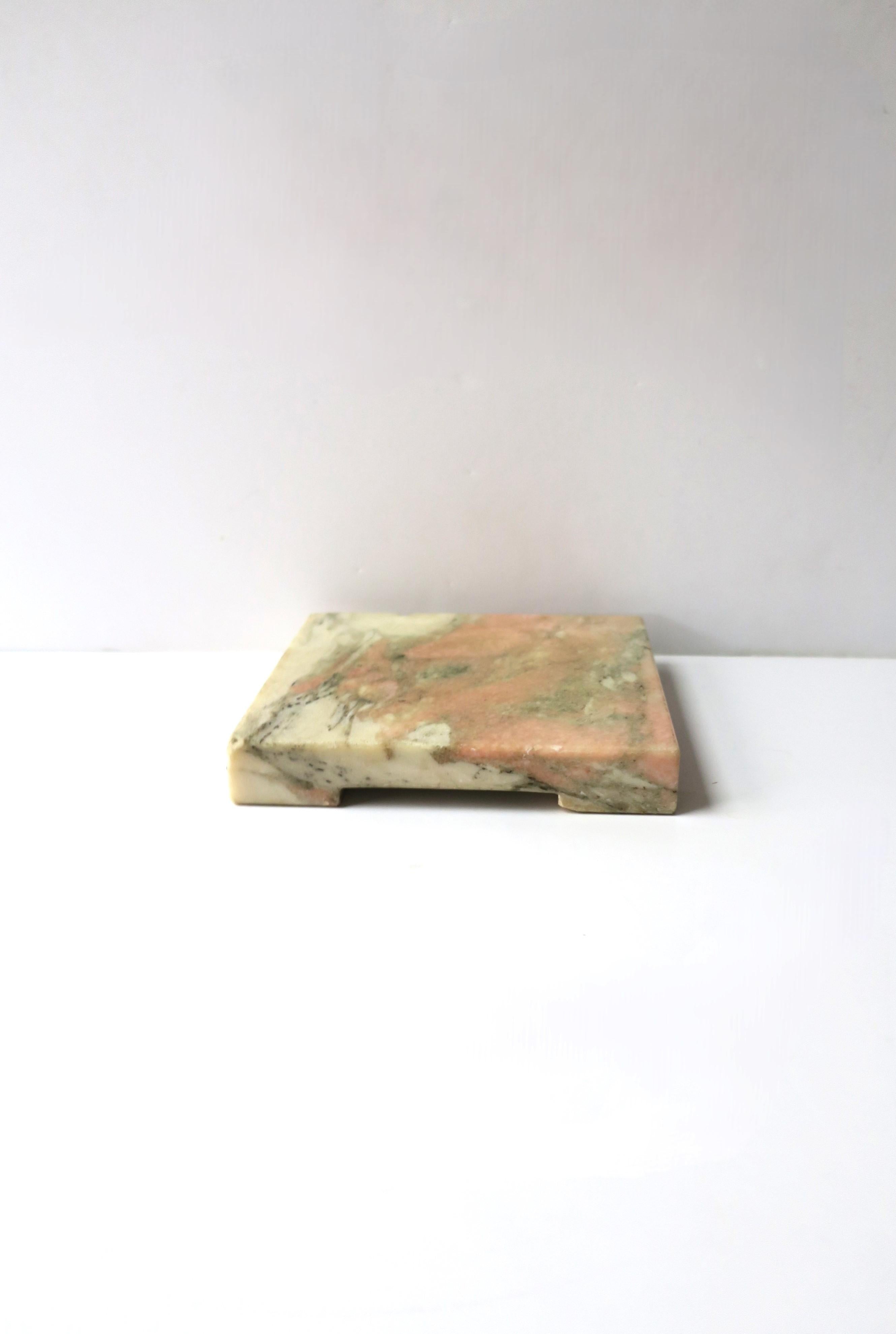 A square marble plinth element, in the Modern style, circa late-20th century. Marble colors include white, pink, and shades of grey and black. Use for sculpture, a plant, a cocktail, a display piece, etc. Many uses. Dimensions: 6