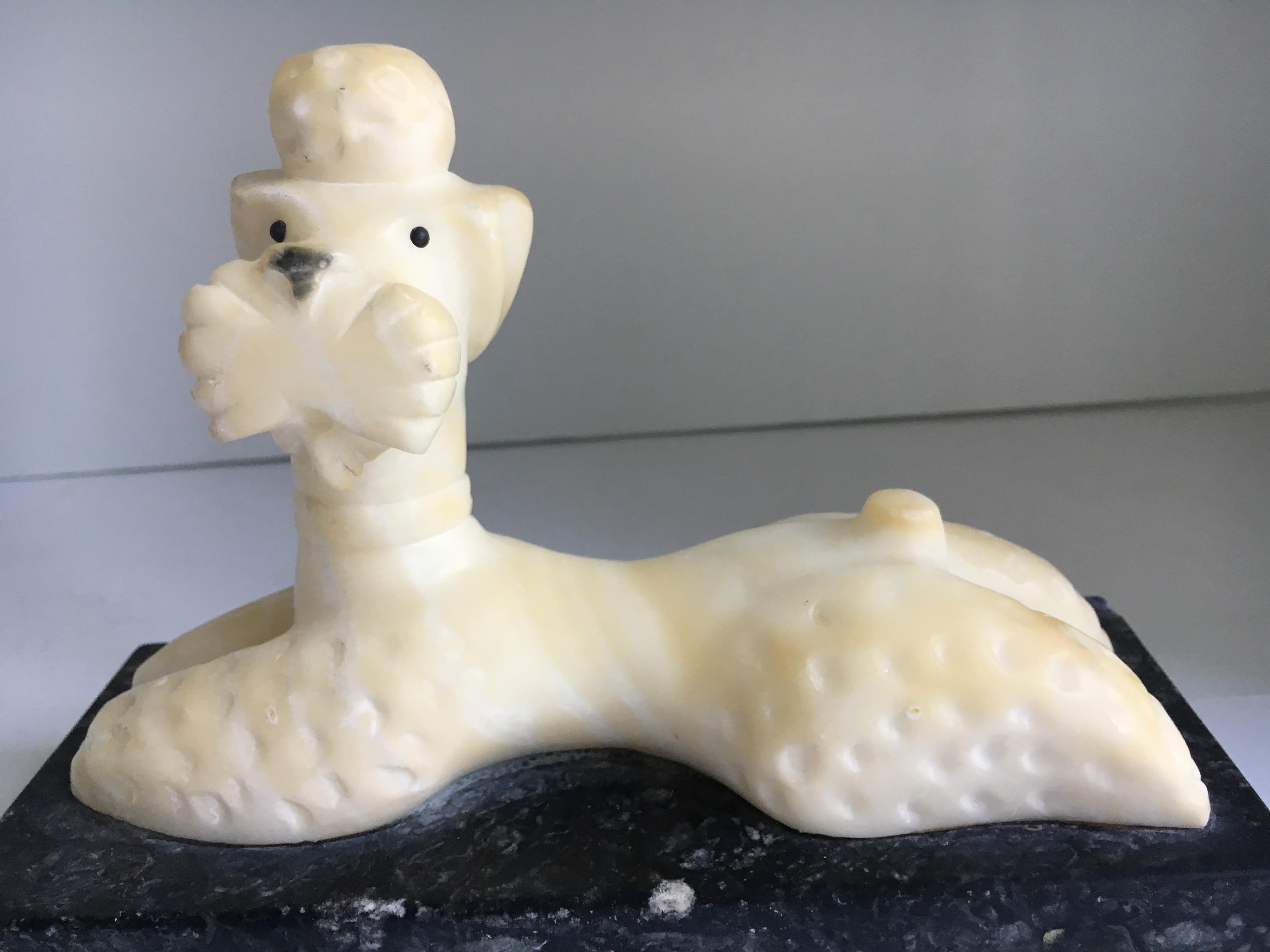 A white marble Poodle relaxing and stretched on a black marble base - perfect for the desk, especially for the dog enthusiast, veterinarian or Poodle aficionado! 

Could be used as a bookend, paper weight or simply as a decorative piece of