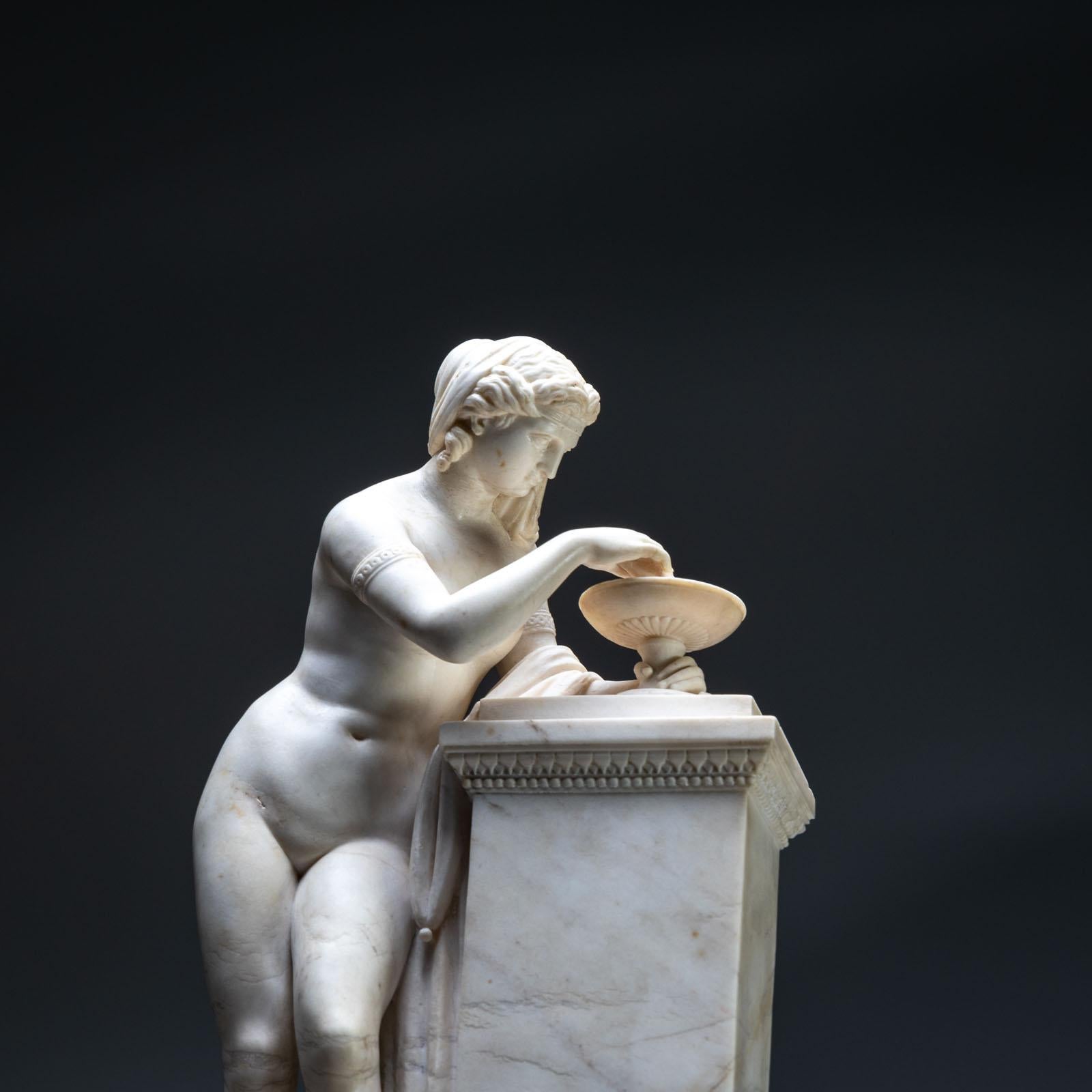 Marble sculpture, probably depicting an undressed nymph with curly hair and bracelets around her upper arms. She is leaning against a pillar and disturbing the surface of the water in the tazza with a staff. The effect of the ripples on the surface