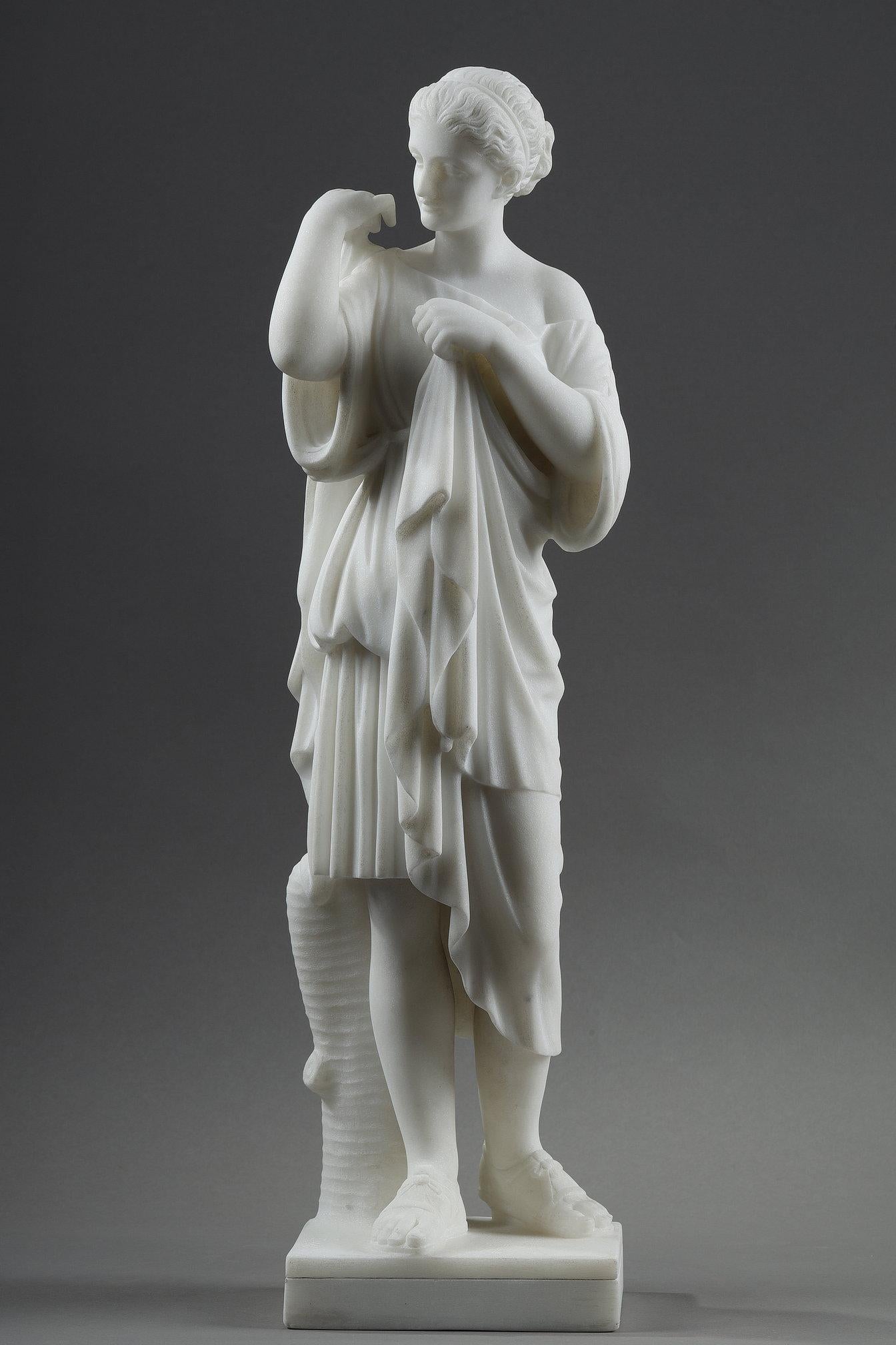 Marble sculpture depicting Artemis, goddess of the hunt, wearing a short tunic and Roman sandals. She fastens her cloak over her right shoulder with a fibula.

Our signed de Pugi sculpture is a late 19th century replica of Artémis dite Diane de
