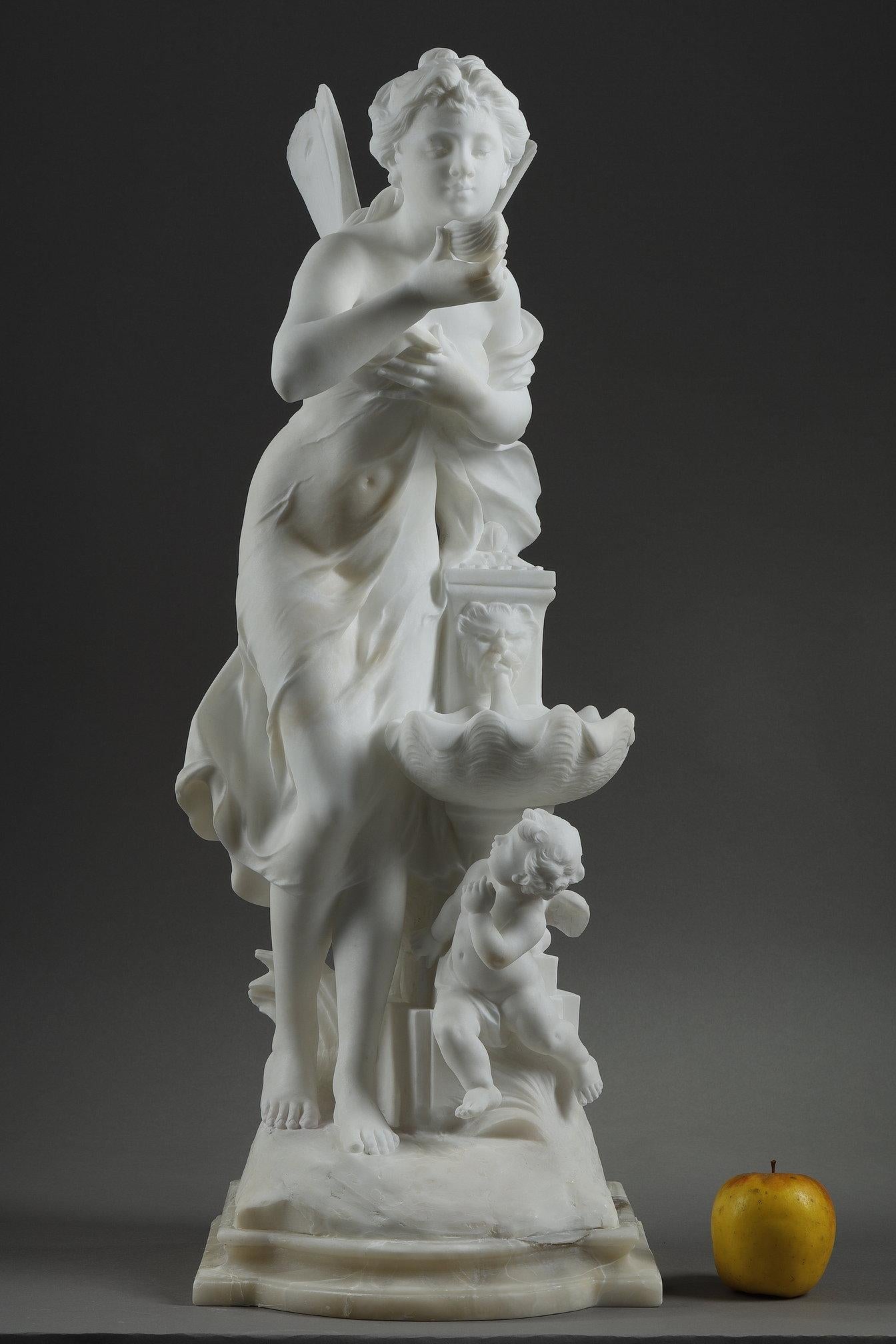 Marble sculpture depicting a Nymph at a fountain. She bends delicately to drink from a shell above a fountain with a faun mask. The winged nymph is lightly draped, revealing her form. Beneath the basin hides an observing Amur. The marble is signed