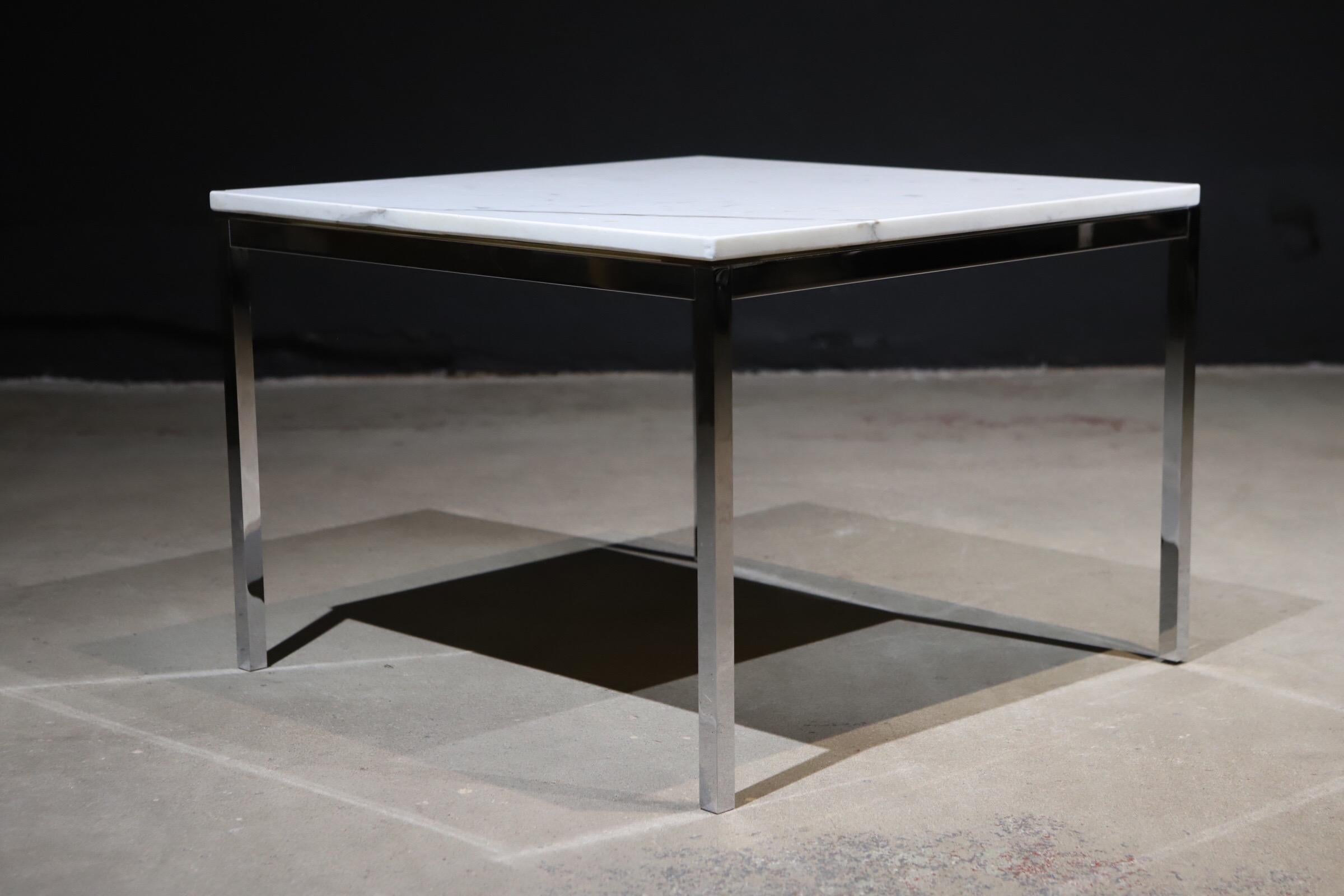 A simplistic and timeless design by Florence Knoll for Knoll. White Carrara marble top side table or cocktail table with chromed square steel legs. Pictured with Harry Bertoia side chair and plywood lounge chairs for scale.