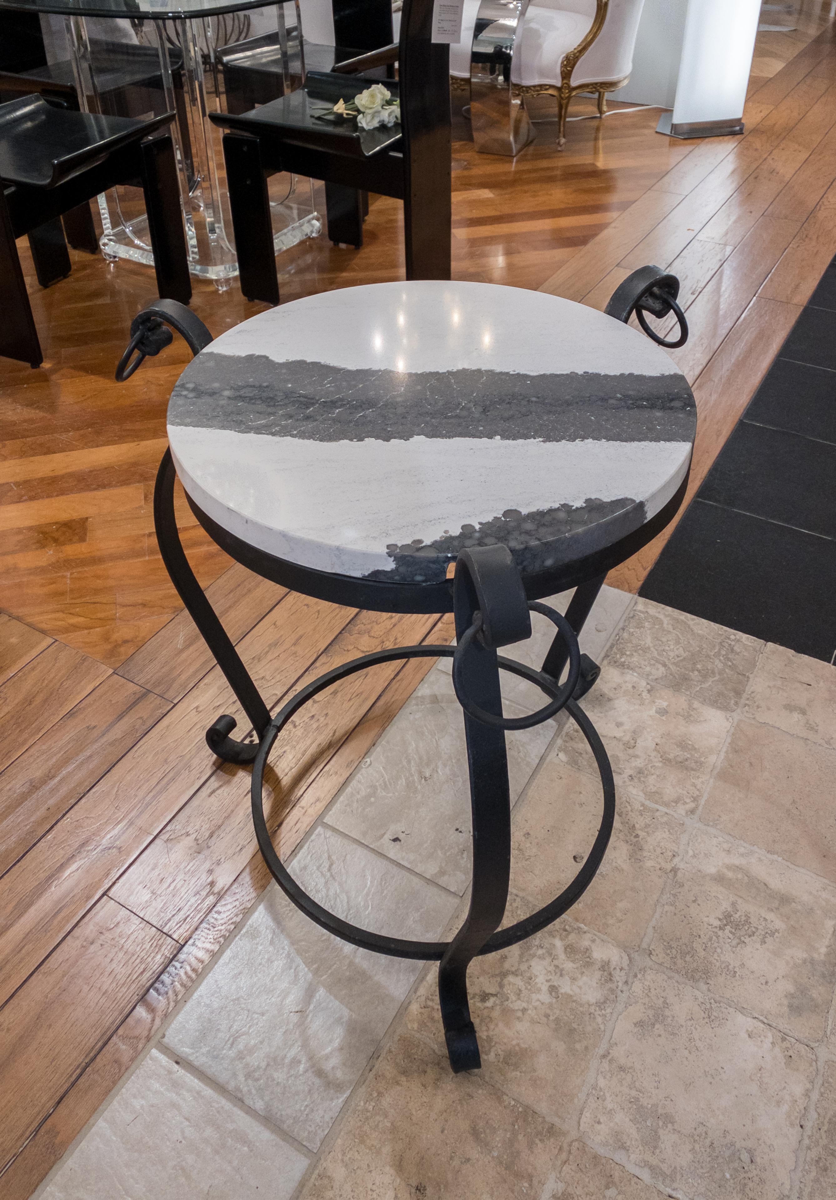 Marble Side Table with three forged legs as supports for the unique marble top.

Crafted to perfection, the marble side table stands as a testament to elegance and artistry. Its unique design boasts a luxurious marble top exuding natural opulence,