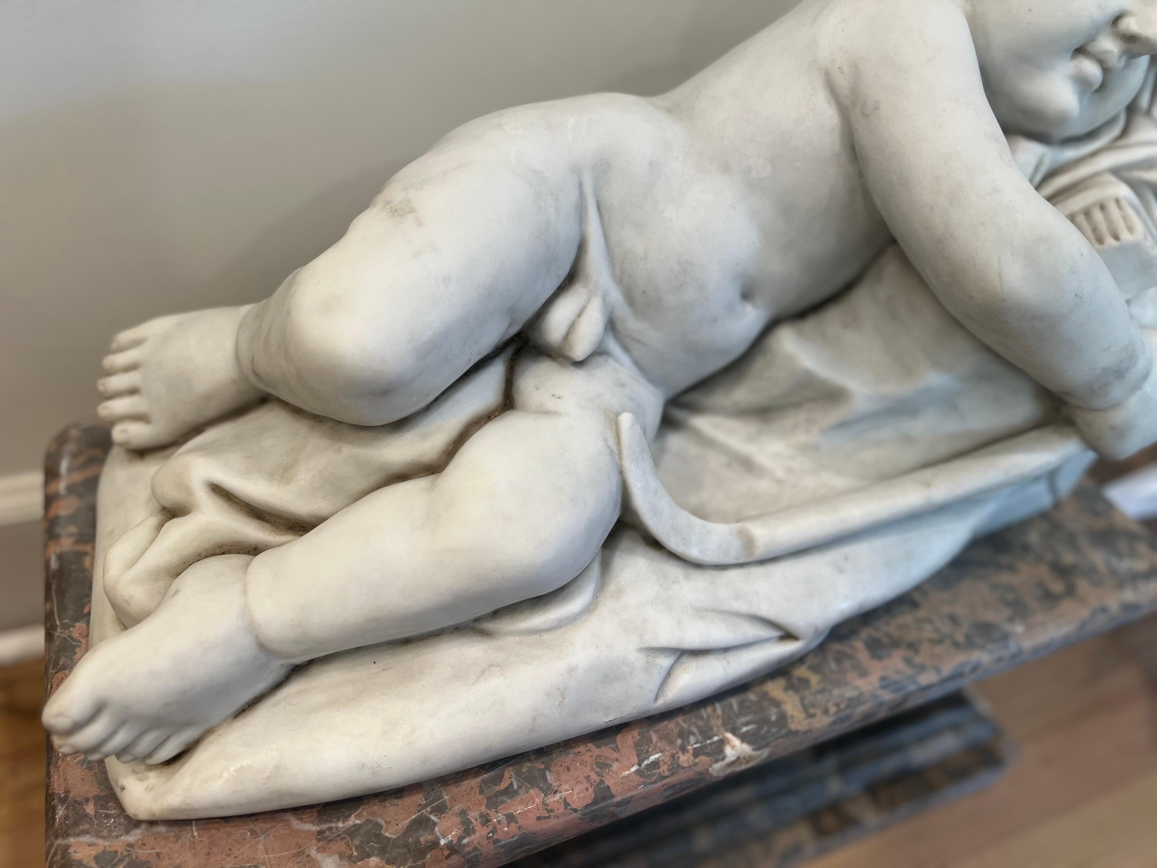 Carved Marble sleeping Cupid Statue in the style of François Duquesnoy For Sale