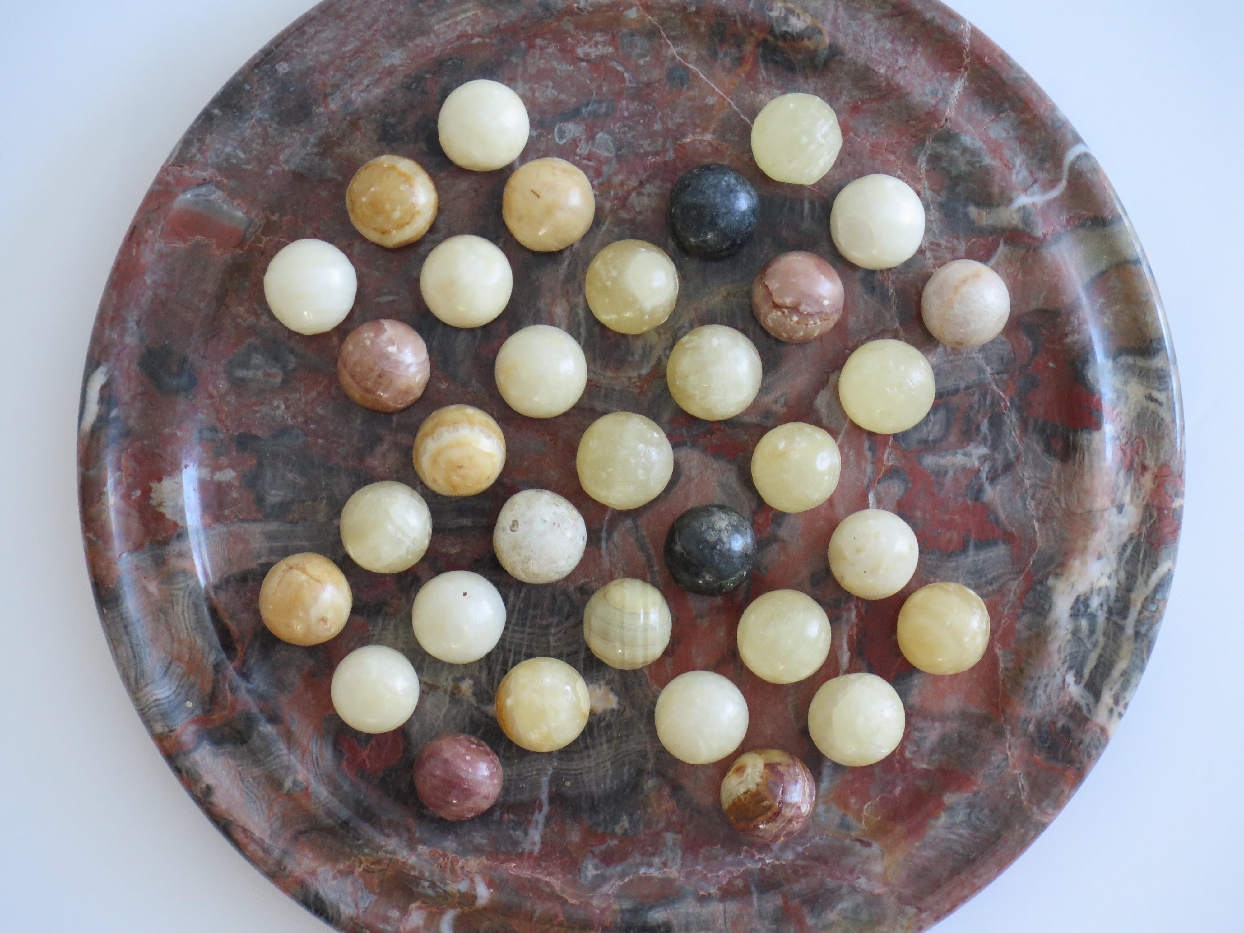 Folk Art Marble Solitaire Board Game Natural Stone Board & 33 Agate Marbles, circa 1930s