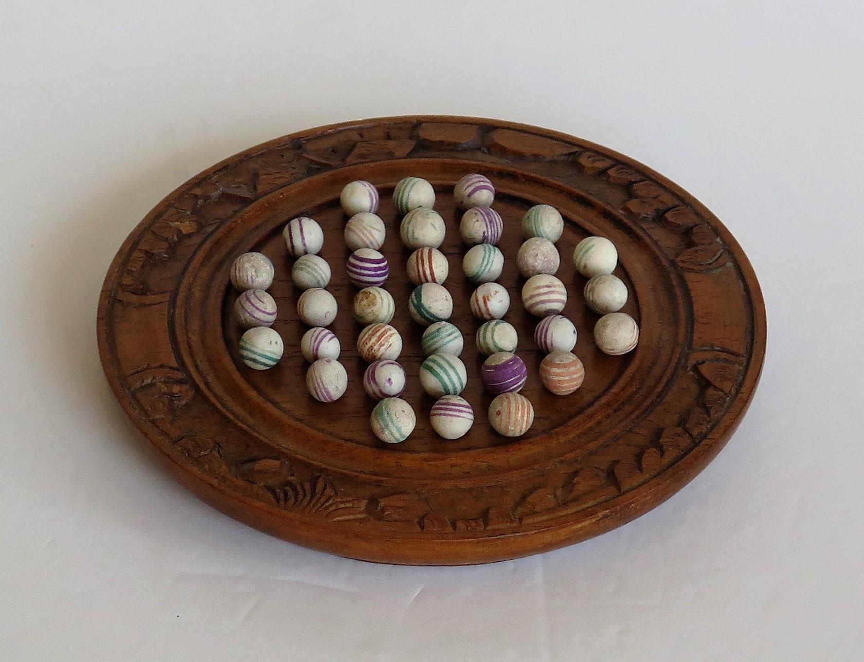 Victorian Marble Solitaire Board Game with 37 Early Handmade Ceramic Marbles, circa 1870