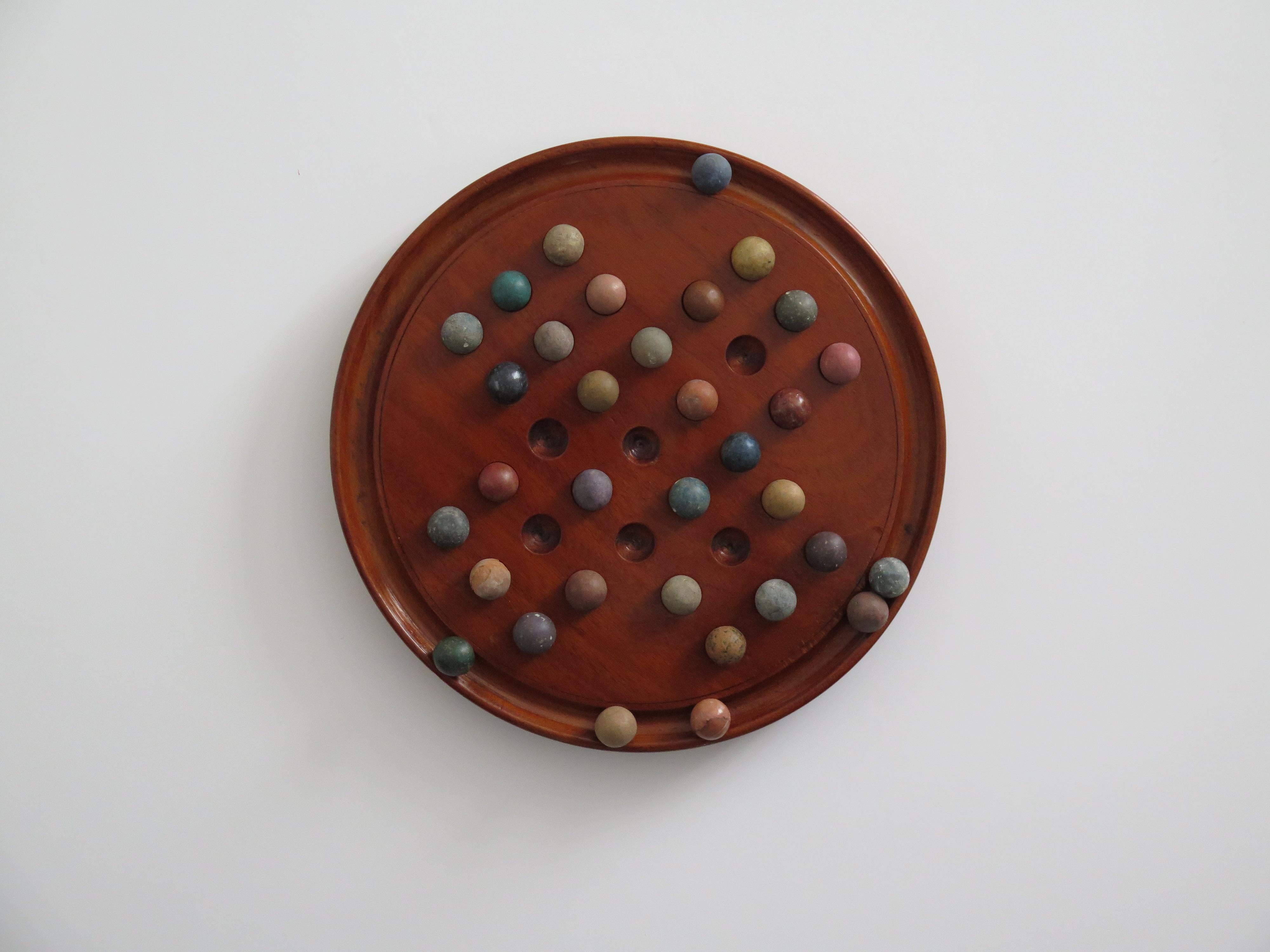 Folk Art Marble Solitaire Fine Hardwood Board with 33 Clay and Stone Marbles, Late 19th C