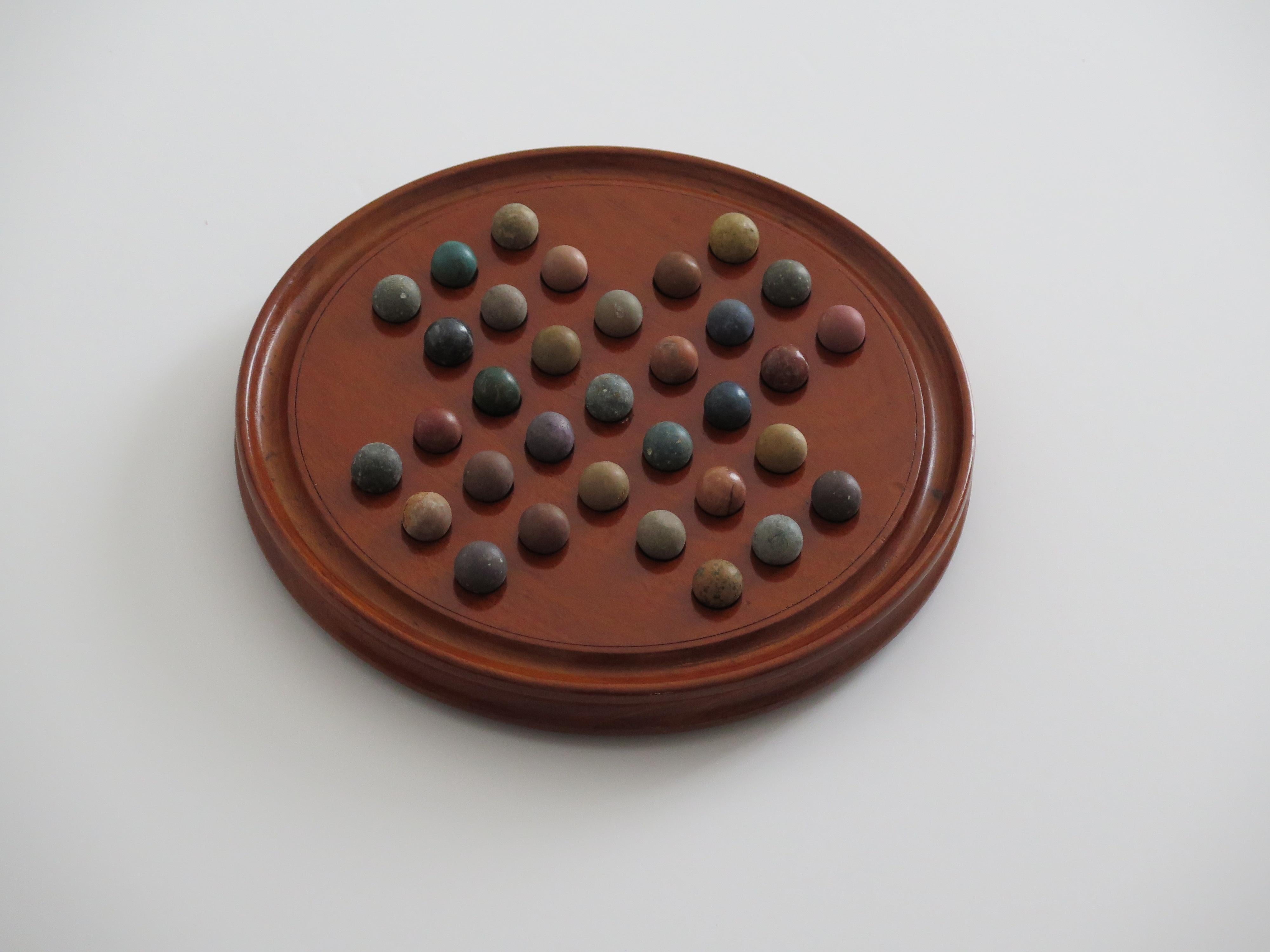 Hand-Crafted Marble Solitaire Fine Hardwood Board with 33 Clay and Stone Marbles, Late 19th C