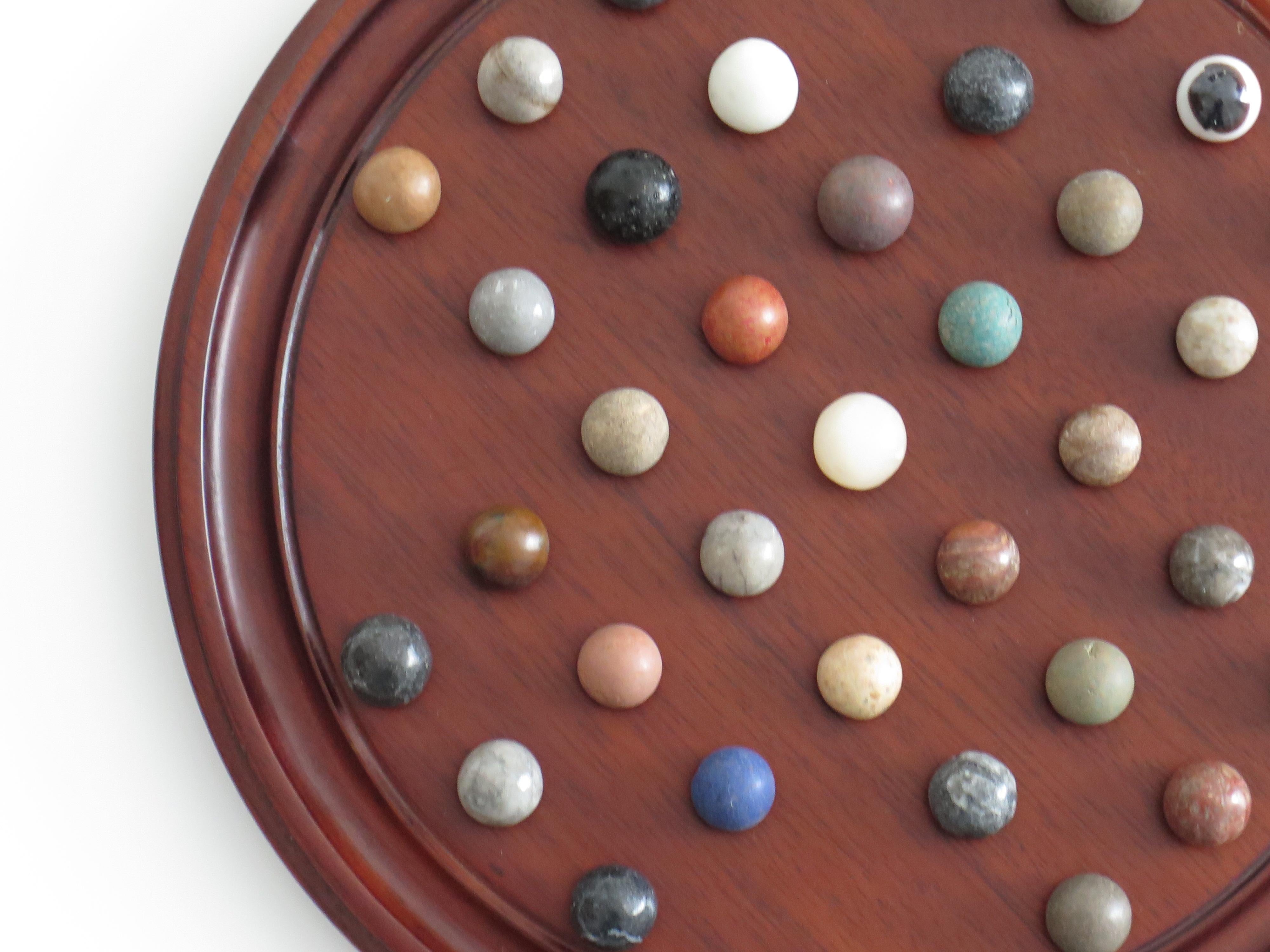 Marble Solitaire Game 10 inch Hardwood Board 35 mixed Stone Marbles, circa 1945 For Sale 4