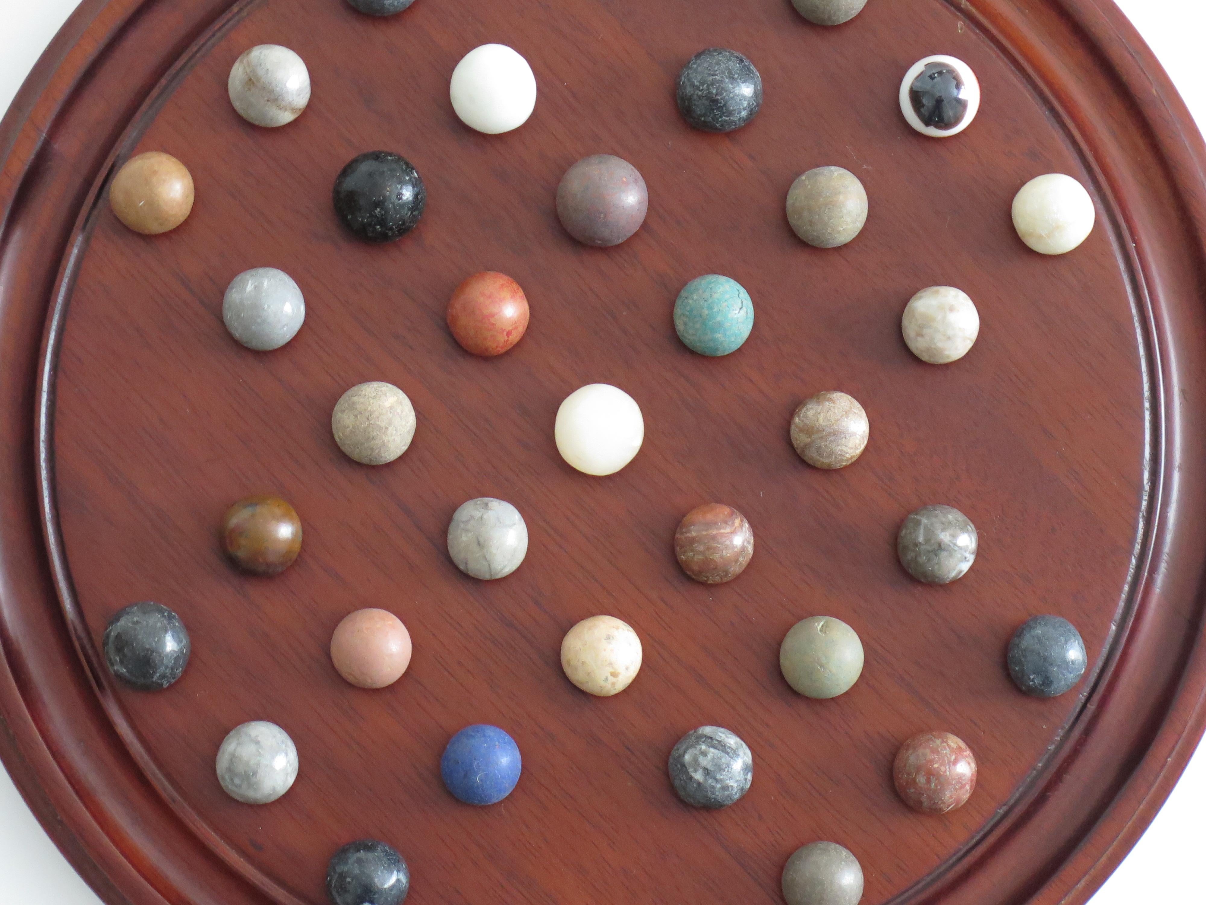 Marble Solitaire Game 10 inch Hardwood Board 35 mixed Stone Marbles, circa 1945 For Sale 5