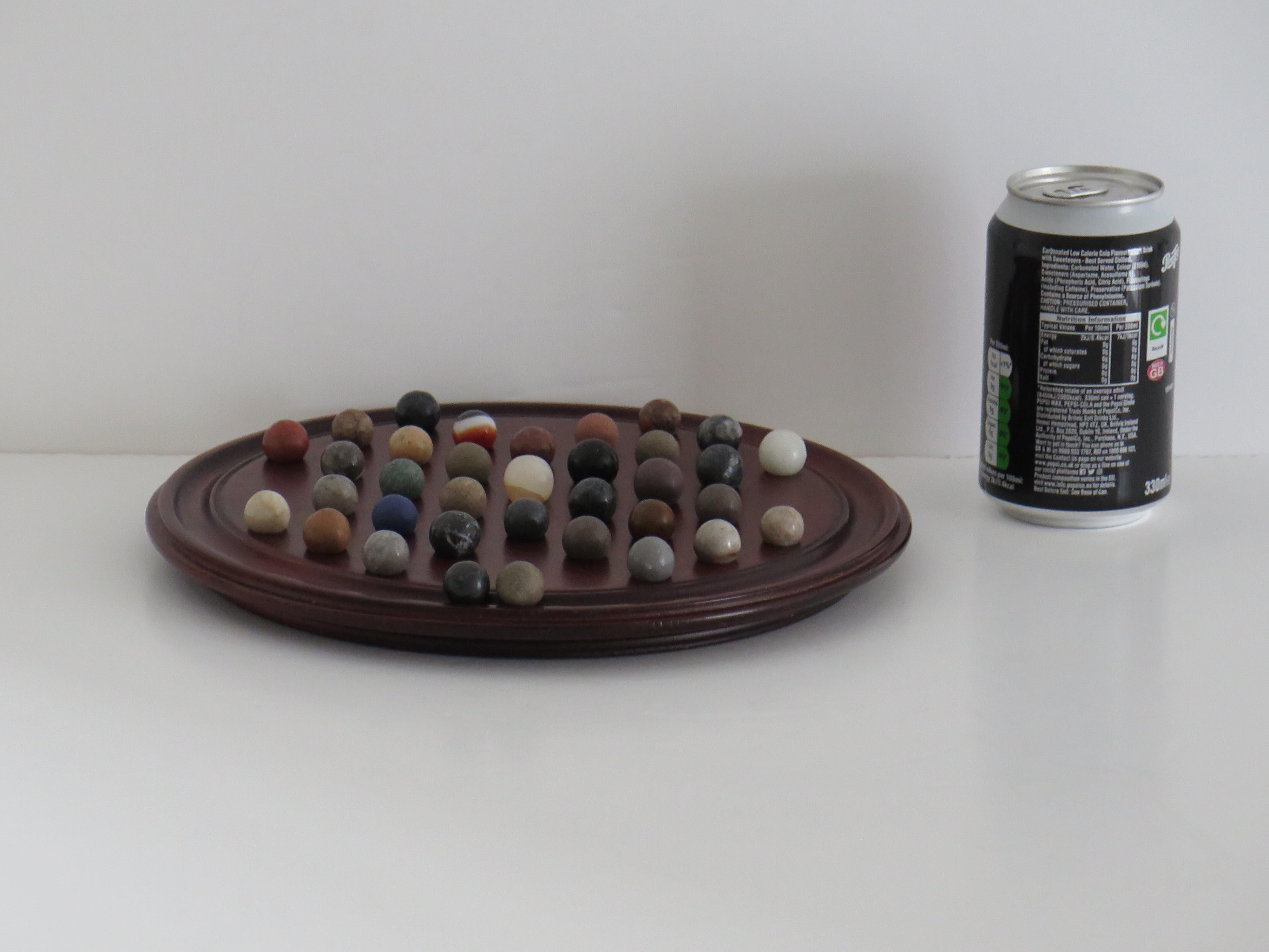 Marble Solitaire Game 10 inch Hardwood Board 35 mixed Stone Marbles, circa 1945 For Sale 10