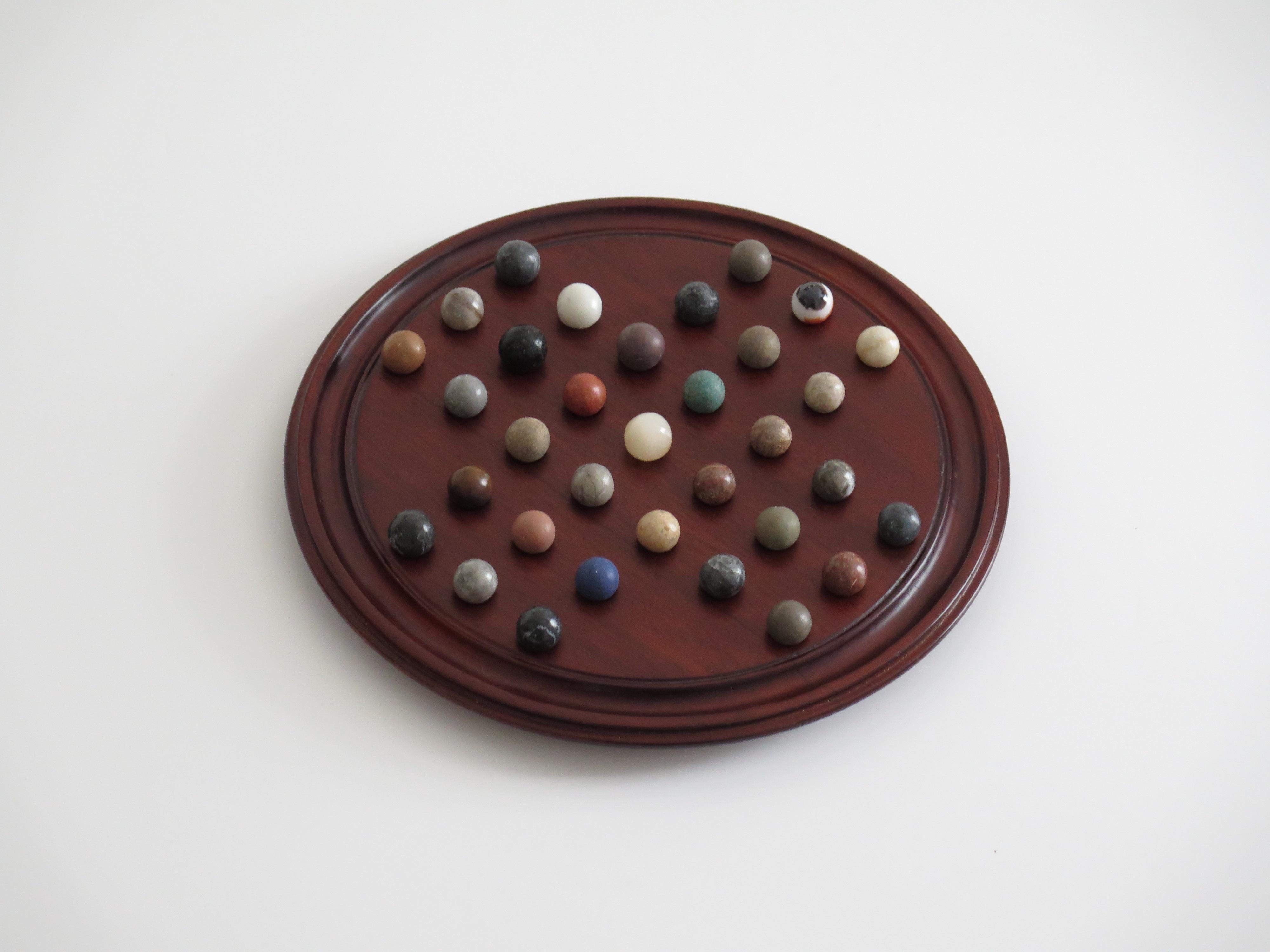 Folk Art Marble Solitaire Game 10 inch Hardwood Board 35 mixed Stone Marbles, circa 1945 For Sale