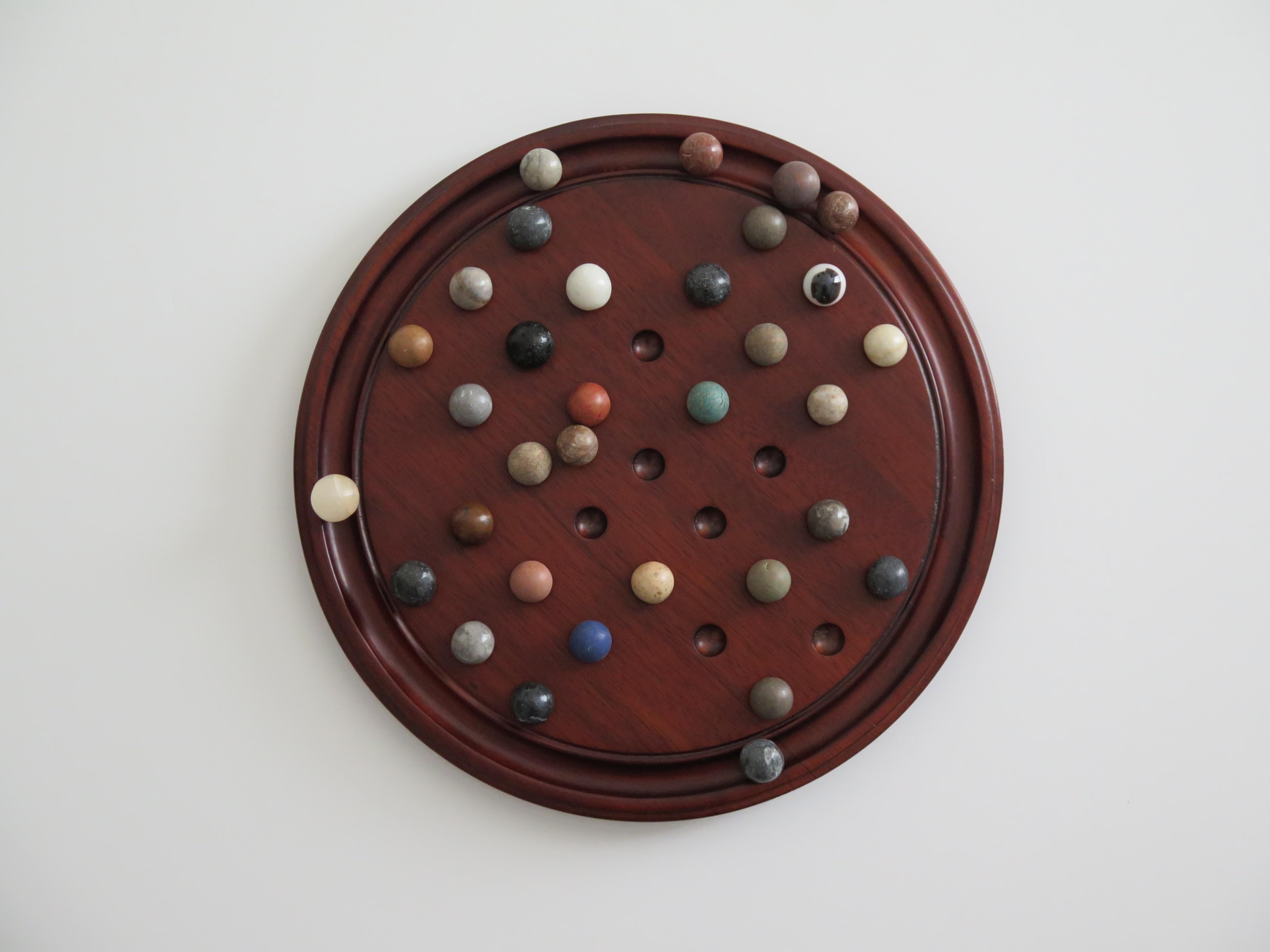 French Marble Solitaire Game 10 inch Hardwood Board 35 mixed Stone Marbles, circa 1945 For Sale