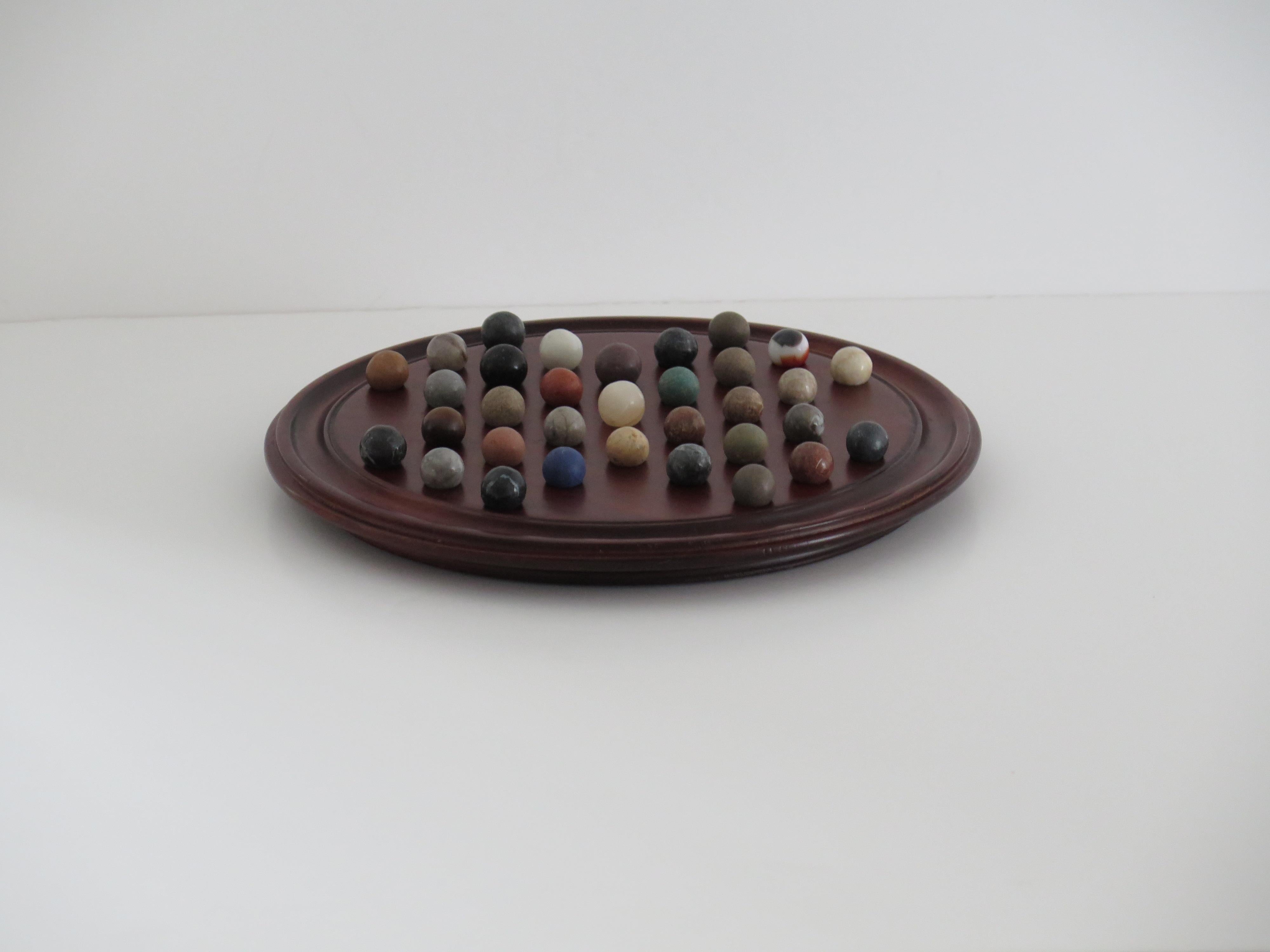 Hand-Crafted Marble Solitaire Game 10 inch Hardwood Board 35 mixed Stone Marbles, circa 1945 For Sale