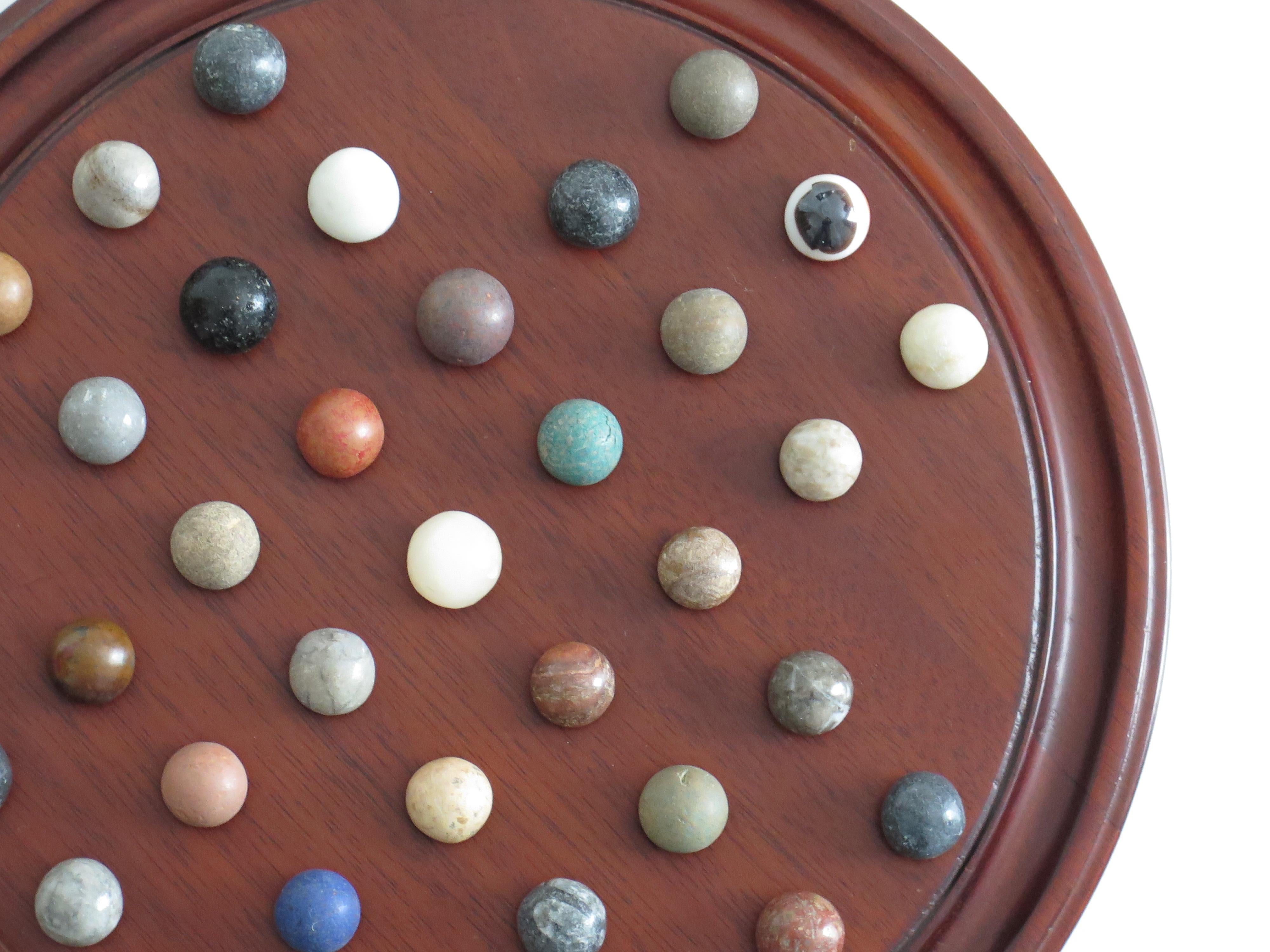 Marble Solitaire Game 10 inch Hardwood Board 35 mixed Stone Marbles, circa 1945 For Sale 2