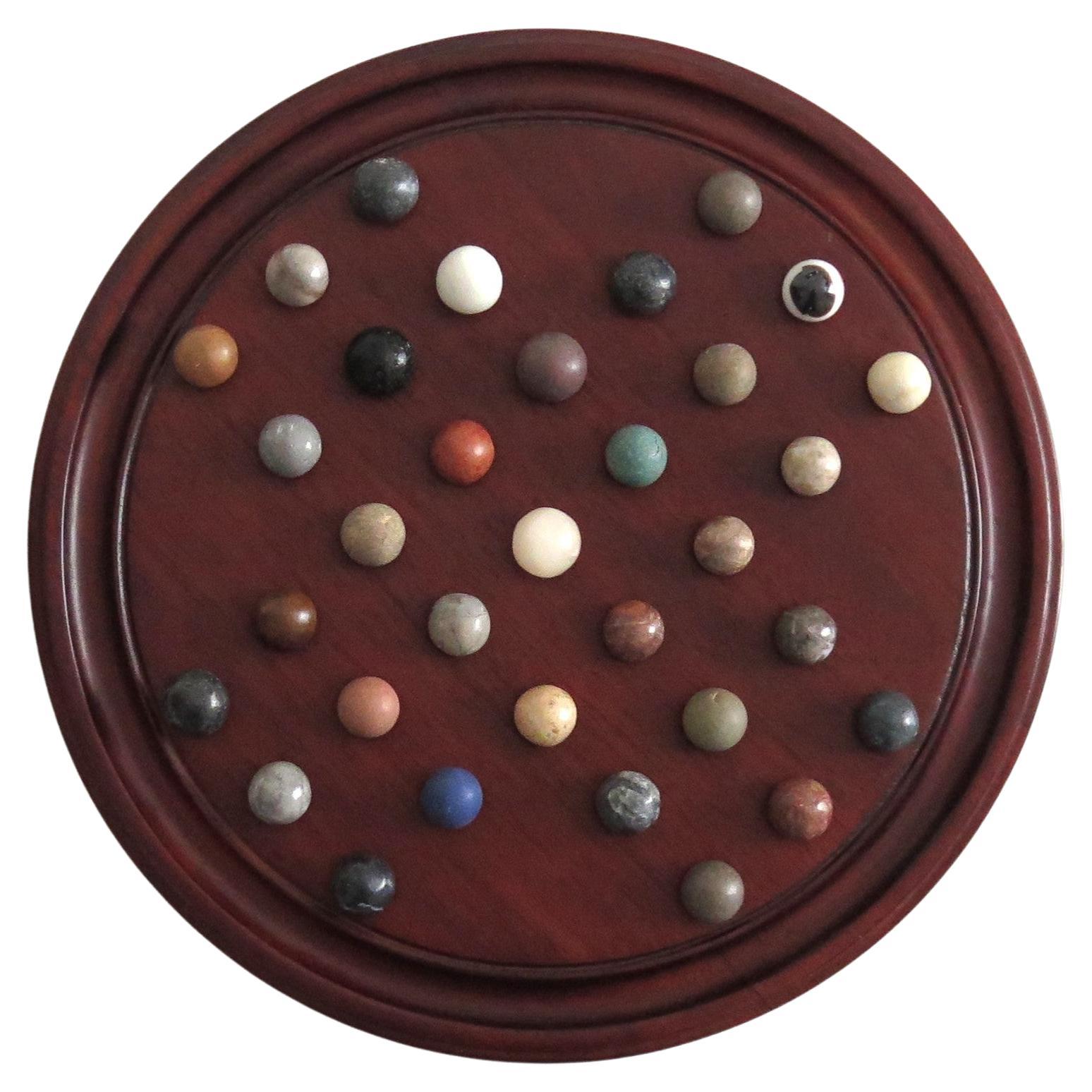 Juego del solitario de mármol Tablero de madera dura de 10 pulgadas 35 canicas mixtas de Stone, circa 1945