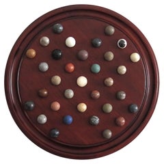 Marble Solitaire Game 10 inch Hardwood Board 35 mixed Stone Marbles, circa 1945
