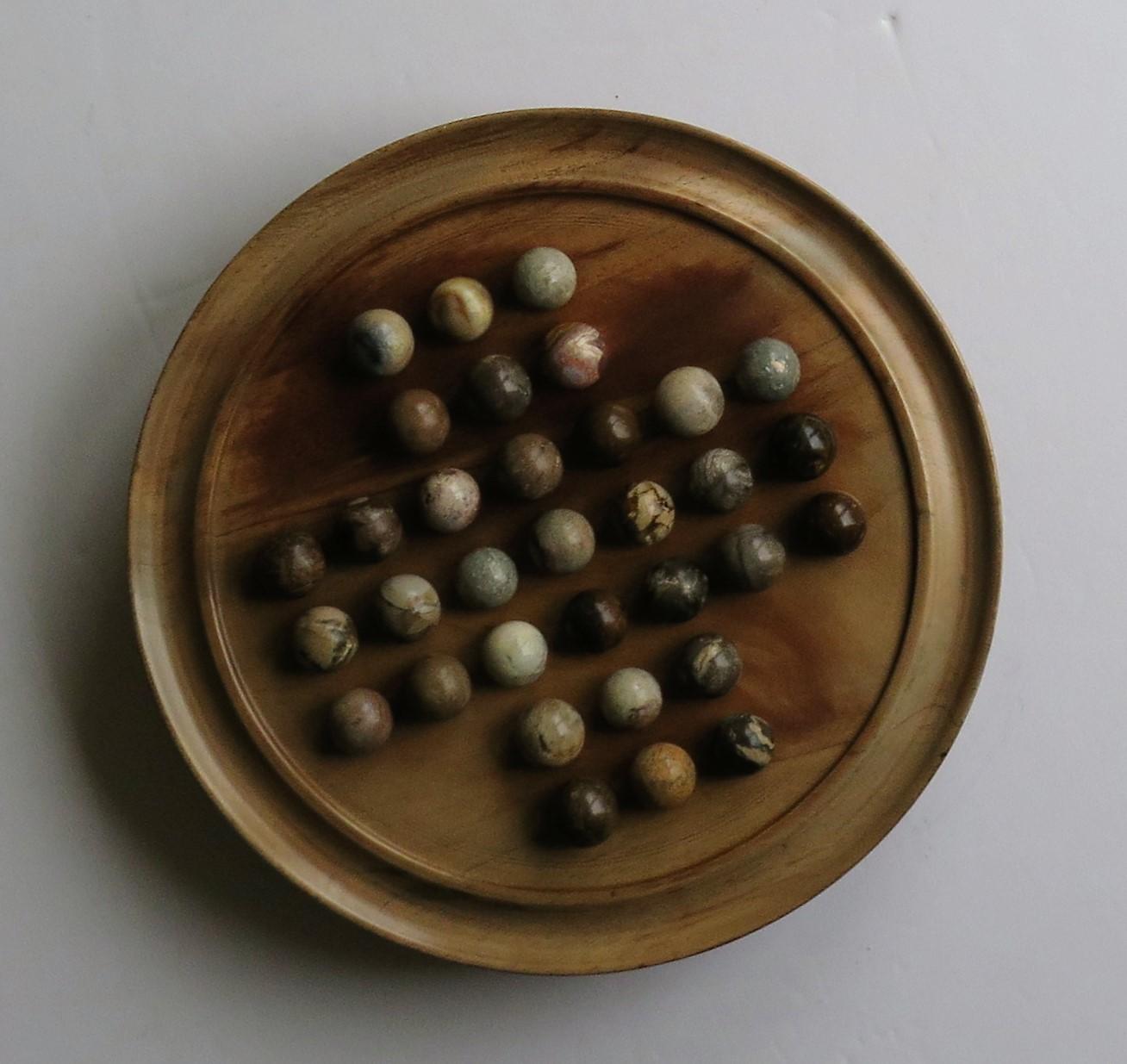 wooden solitaire game with marbles