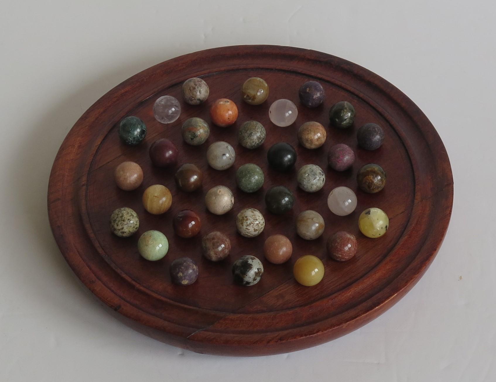 Hand-Crafted Marble Solitaire Game Hardwood Board 37 Agate Mineral Stone Marbles, circa 1915