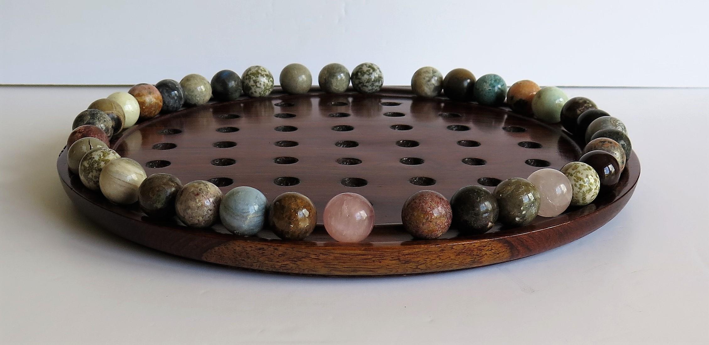 20th Century Marble Solitaire Game Polished Hardwood Board 36 Agate Stone Marbles, circa 1915