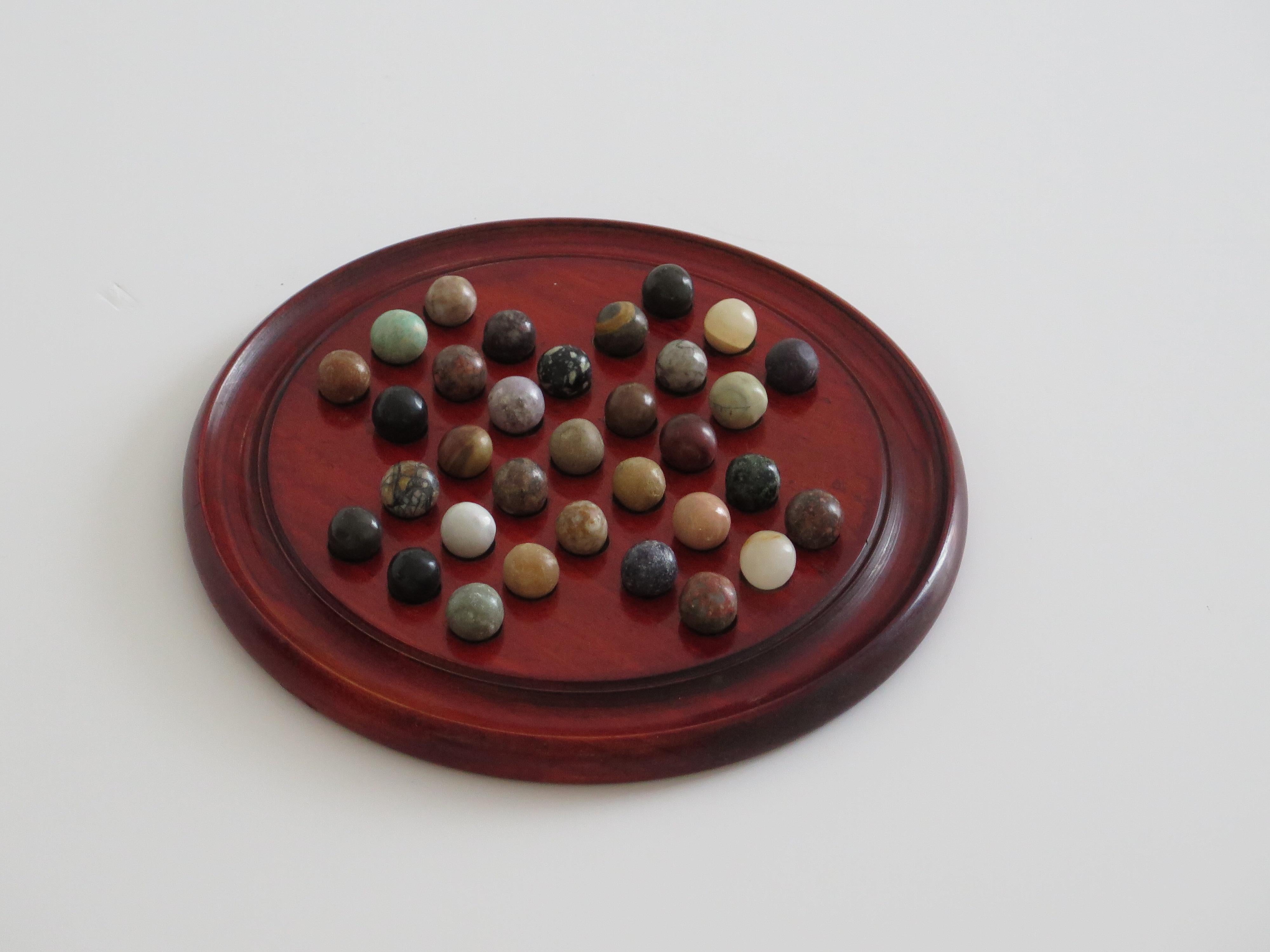 Art Deco Marble Solitaire Game with hardwood board and 33 agate stone Marbles, Circa 1925 For Sale